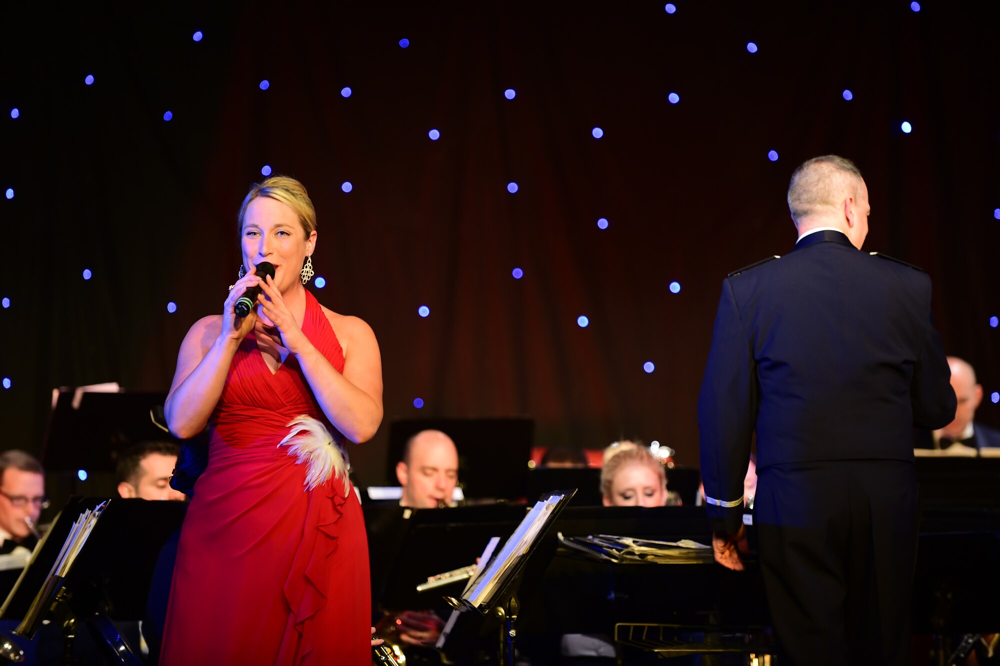 Staff Sgt. Jill Diem, sings “Underneath the Christmas Tree,” during the U.S. Air Forces in Europe Concert band holiday celebration at Burgess Hall in St. Ives, Cambridgeshire, England, Dec. 18, 2014. The USAFE band concerts are intended not only to entertain, but also to bridge relationships with the community members. (U.S. Air Force photo by Tech. Sgt. Chrissy Best)