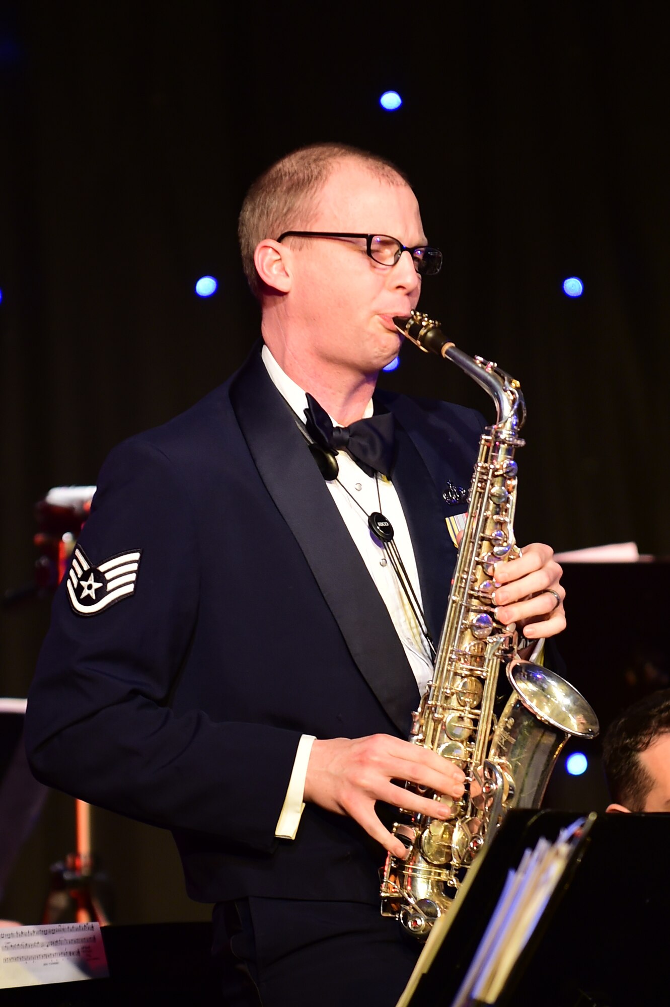Staff Sgt. Nathan Herald plays an alto saxophone solo during the U.S. Air Forces in Europe Concert band holiday celebration at Burgess Hall in St. Ives, Cambridgeshire, England, Dec. 18, 2014. This concert was the USAFE band’s 17th concert of their 20-concert holiday tour. (U.S. Air Force photo by Tech. Sgt. Chrissy Best)