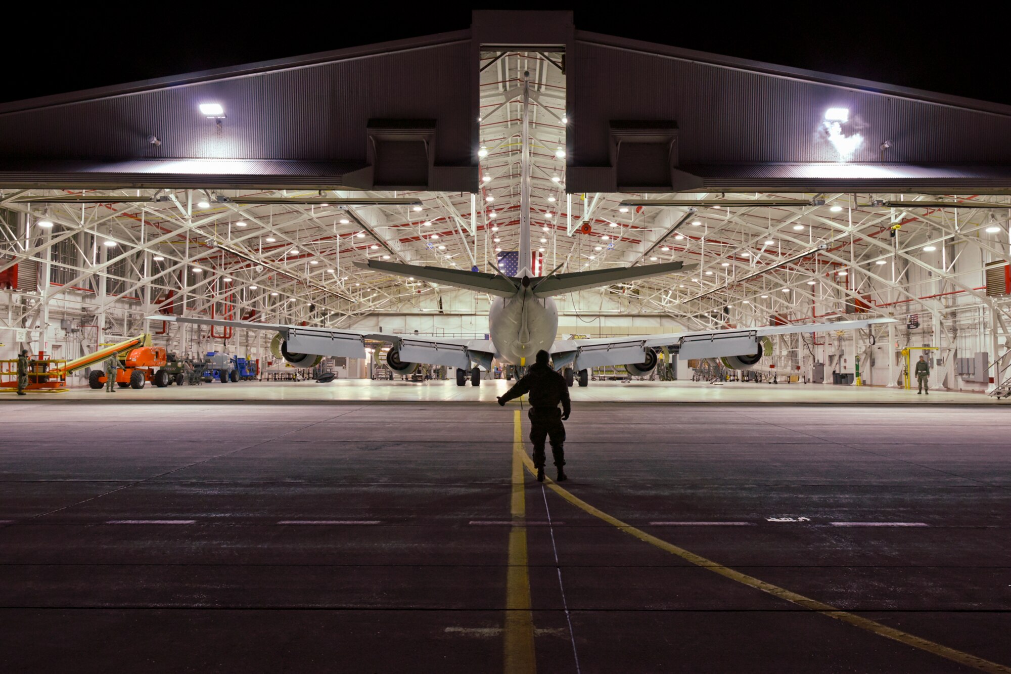 Airmen of the 191st Aircraft Maintenance Squadron begin their day by towing a KC-135 Stratotanker out of a hangar at Selfridge Air National Guard Base, Mich., in the pre-dawn hours of Dec. 19, 2014. Each aircraft undergoes a complete inspection, known as an ISO or isochronical inspection, at various points in the aircraft’s operational cycle. (U.S. Air National Guard photo by Terry Atwell)