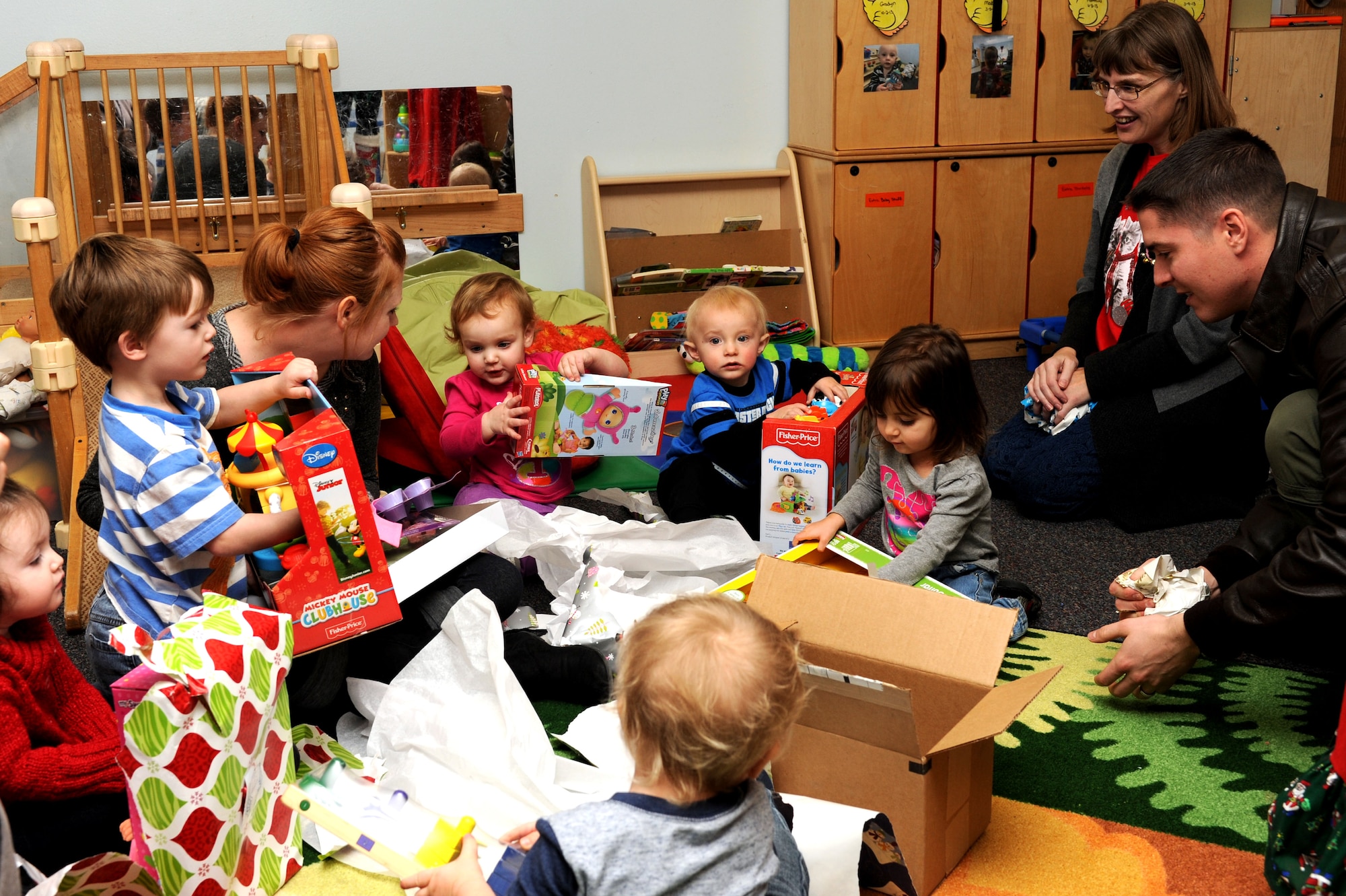 Children open gifts at the Youth & Family Services Child Development Center in Rapid City, S.D., Dec. 16, 2014. (U.S. Air Force photo by Senior Airman Hailey R. Staker/Released)