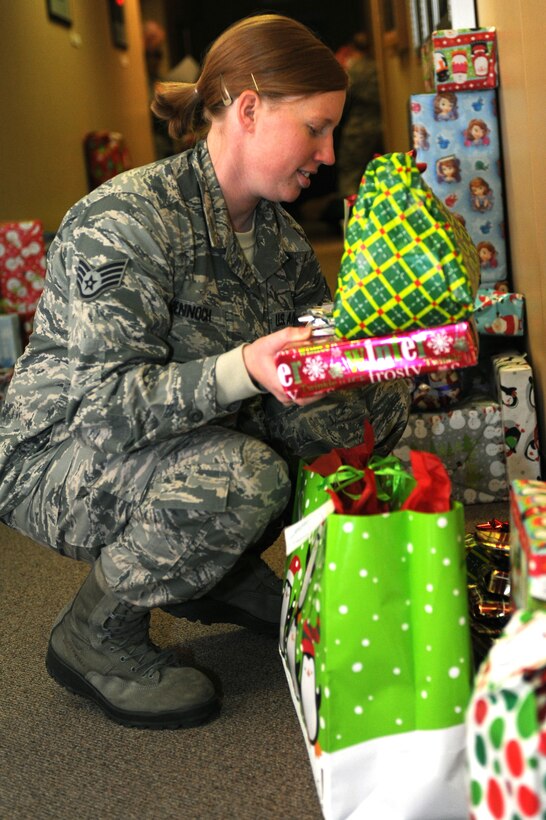 Staff Sgt. Crystal Bennoch, 28th Operations Support Squadron NCO in charge of airfield management operations and volunteer, sorts gifts into categories in preparation for the 28th Operations Group Angel Tree program at Ellsworth Air Force Base, S.D., Dec. 15, 2014. This year marks the eighth year volunteers from the 28th Operations Group have conducted the program intended to make a difference in the lives of children and families in the community during the holiday season and further strengthen the relationship Ellsworth has with the local communities. (U.S. Air Force photo by Senior Airman Hailey R. Staker/Released)