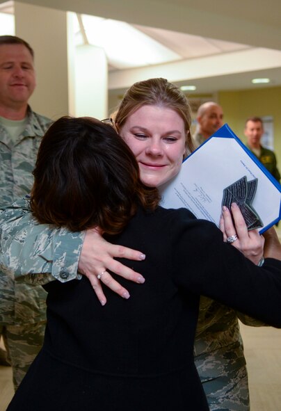 U.S. Air Force Tech Sgt. Shanna Sullivan, 23d Medical Group NCO in charge of outpatient records, hugs Sinetta Blunt, 23d Medical Group patient safety, after being promoted to Technical Sergeant in a Stripes for Exceptional Performers (STEP) promotion Dec. 18, 2014 at Moody Air Force Base, Ga.  Sullivan received the surprise promotion from Col. Chad Franks, 23d Wing commander, while she was at work. (U.S. Air Force photo by Airman 1st Class Kathleen Bryant/Released)