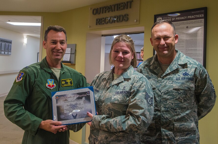 U. S. Air Force Col. Chad Franks, 23d Wing commander, left, Tech. Sgt. Shanna Sullivan, 23d Medical Group NCO in charge of outpatient records, and Chief Master Sergeant David Kelch, 23d Wing command chief, pose for a photo Dec. 18, 2014 at Moody Air Force Base, Ga.  Franks and Kelch surprised Sullivan at work and announced that she was being STEP promoted from staff sergeant to technical sergeant. (U.S. Air Force Airman 1st Class Ceaira Tinsley/Released)