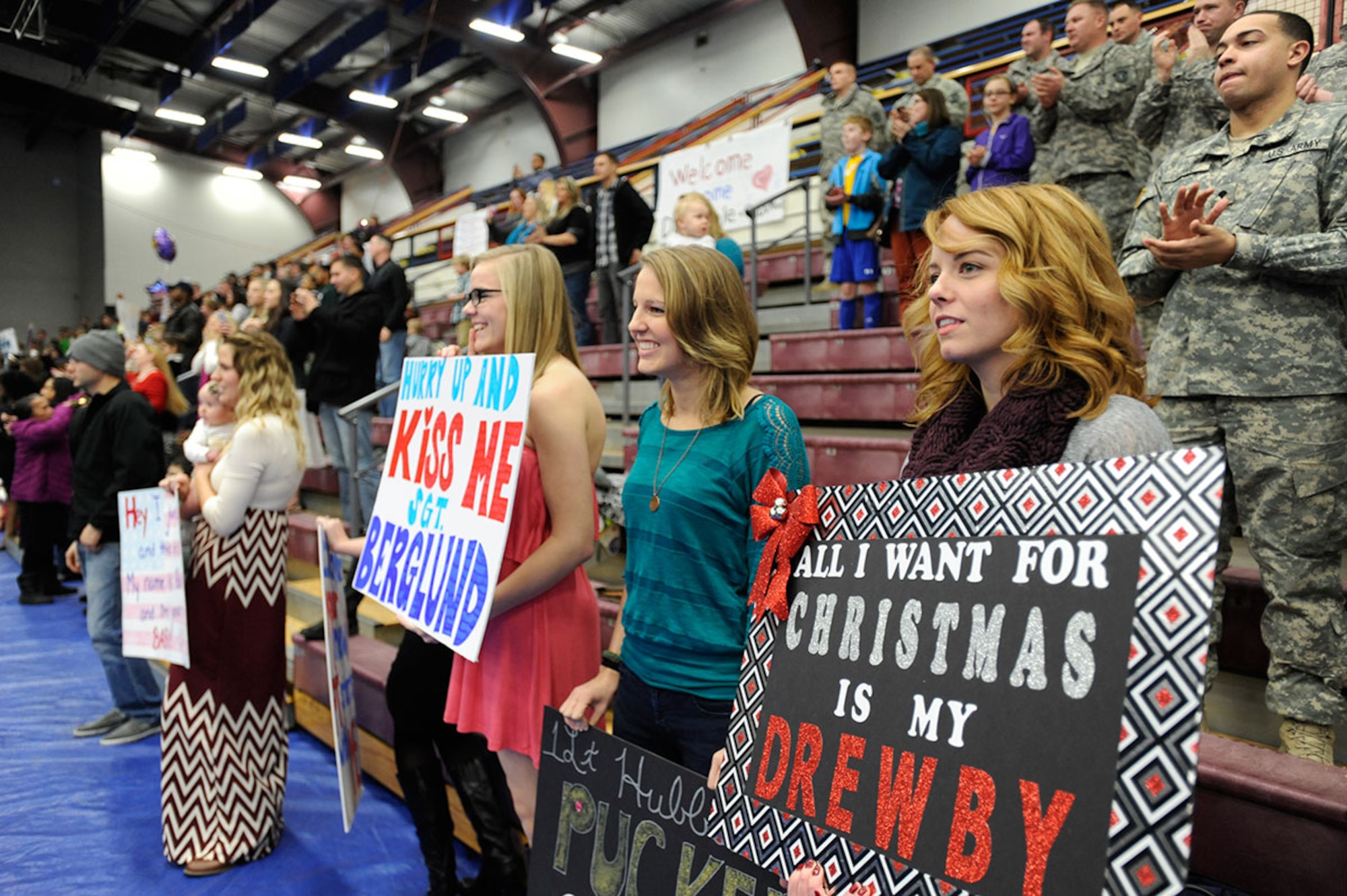 Friends and families wait for the return of their loved ones at Joint Base Elmendorf-Richardson, Alaska, Dec. 14, 2014. Many made signs and put up decorations like balloons to greet their military sponsors home from deployment in Afghanistan. (U.S. Air Force photo/Staff Sgt. Robert Barnett)