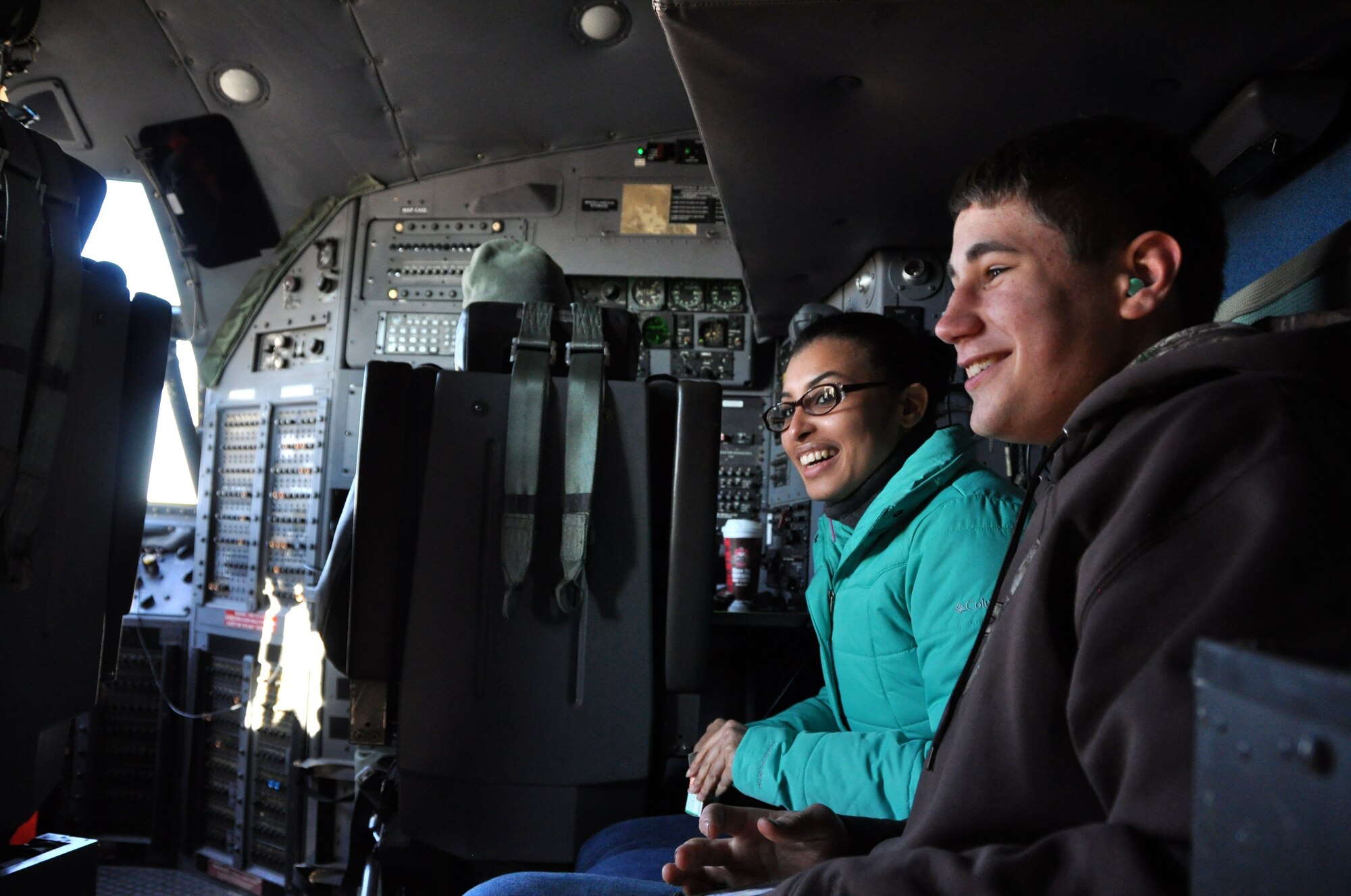 Asia Boyd-Davis, left, and Josh Schuckers, both trainees with 911th Development and Training Flight, sit on the flight-deck, they were invited to the front on the first flight of their lives, Dec. 7, 2014, at Pittsburgh International Airport Air Reserve Station, Pa. (U.S. Air Force photo by Senior Airman Joseph E. Bridge)