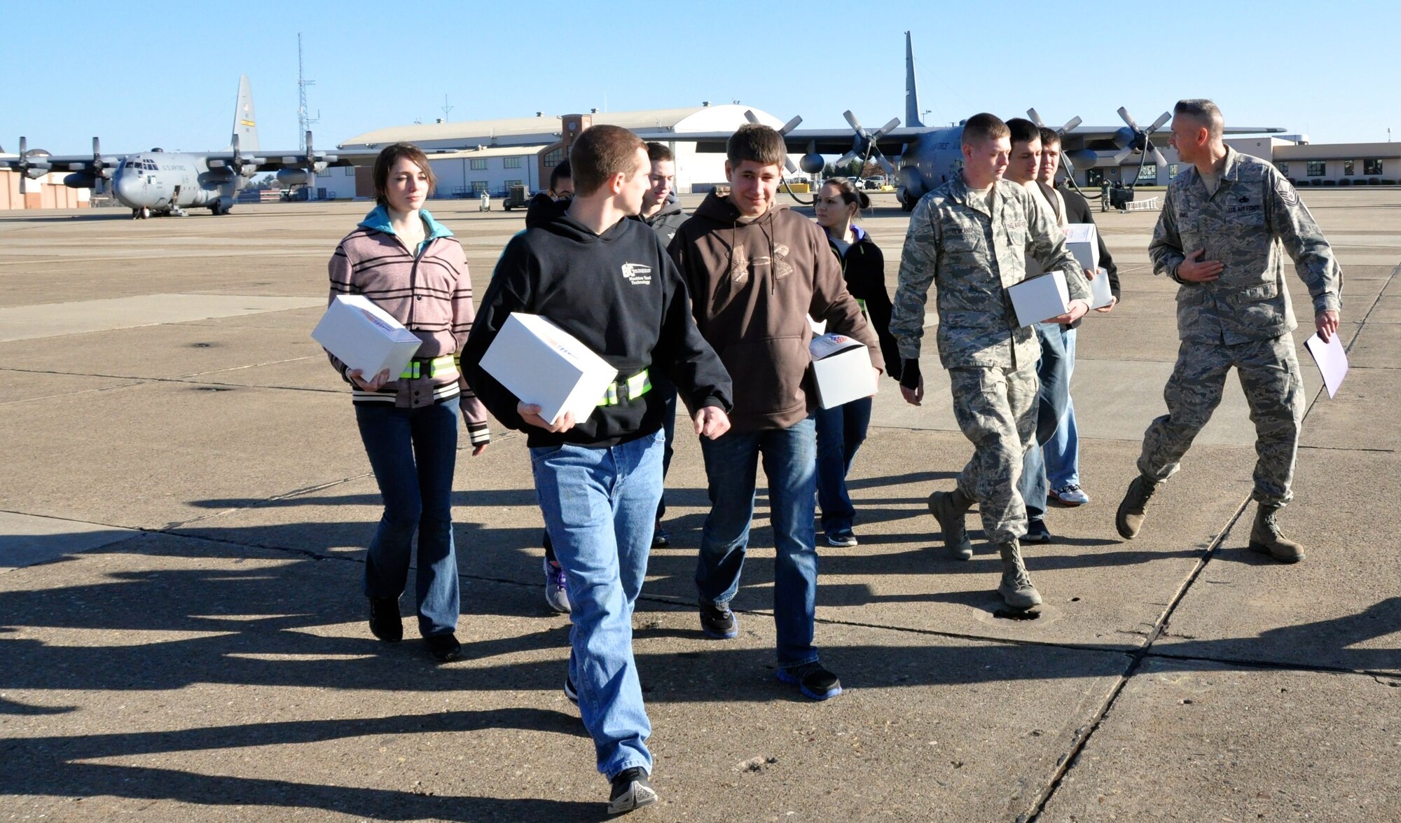 Trainees are walked on the flight-line by Master Sgt. Val R. Armel, the leader of the Development and Training Flight, to the plane awaiting their arrival for take off on an aero-medical training flight, Dec. 7, 2014, at Pittsburgh International Airport Air Reserve Station, Pa. The Development and Training Flight has been in existence for over two years and has put into United States Air Force Basic Military Training roughly 150 trainees. (U.S. Air Force photo by Senior Airman Joseph E. Bridge)