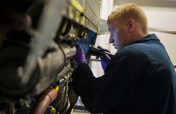 U. S. Air Force Airman 1st Class Cole- Jacob Lipke, 23d Equipment Maintenance Squadron aerospace propulsion craftsman, looks for discrepancies in the engine during an isochronal inspection Dec. 8, 2014, at Moody Air Force Base, Ga. Lipke used the flashlight to lighten dark spaces and confirm all discrepancies were fixed properly. (U.S. Air Force photo by Airman 1st Class Ceaira Tinsley/Released)