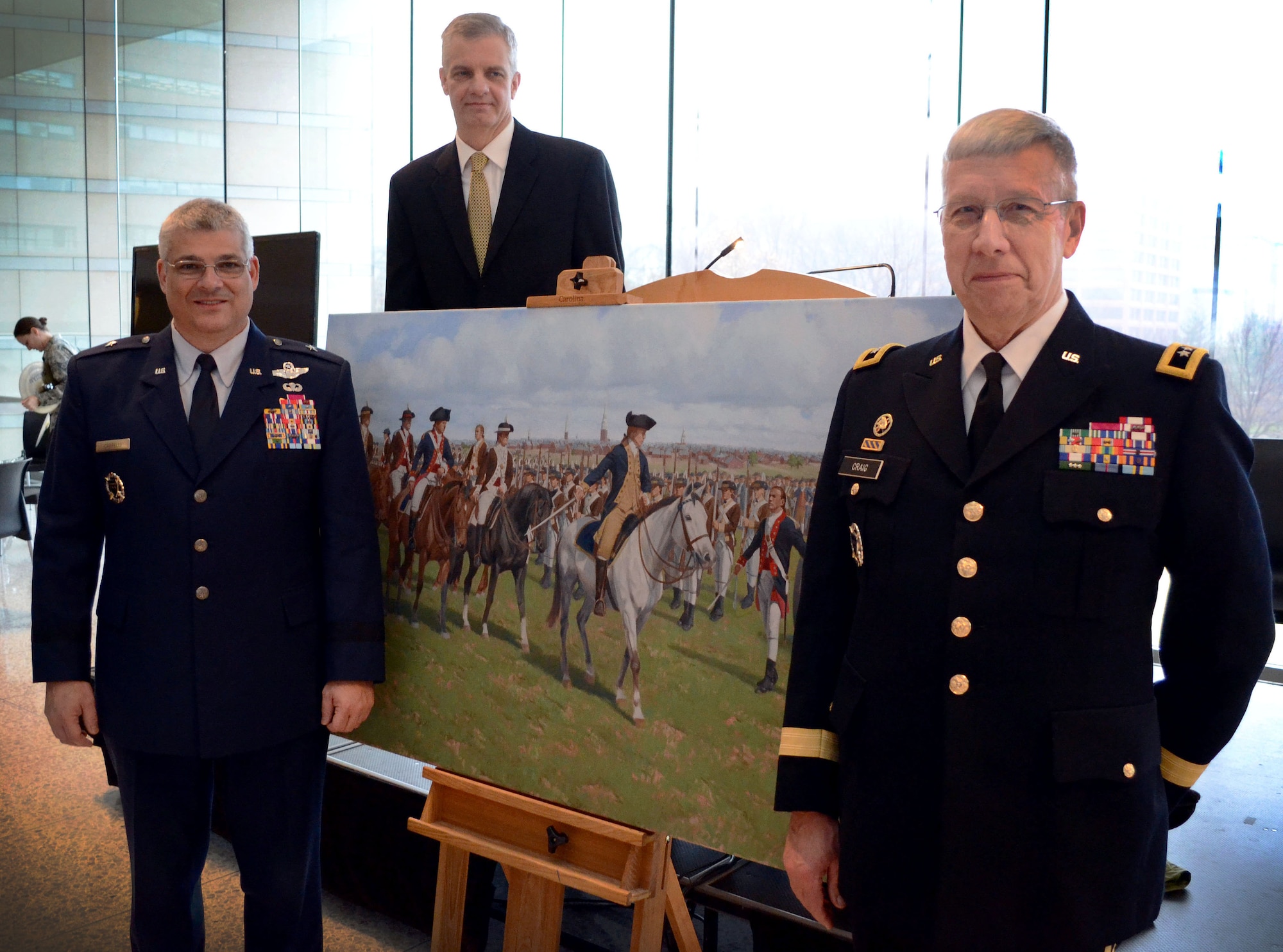Brig. Gen. Tony J. Carrelli, Pennsylvania National Guard deputy adjutant general – air (left), Maj. Gen. Wesley E. Craig, Pa. National Guard adjutant general (right) and artist Larry Selman pose in front of Selman’s painting, “Washington’s Review”, Dec. 6, 2014, at the National Constitution Center, Philadelphia, Pa. The painting was commissioned on behalf of the Pa. National Guard and unveiled during its 267th birthday celebration. (U.S. Air National Guard photo by Master Sgt. Christopher Botzum/Released)