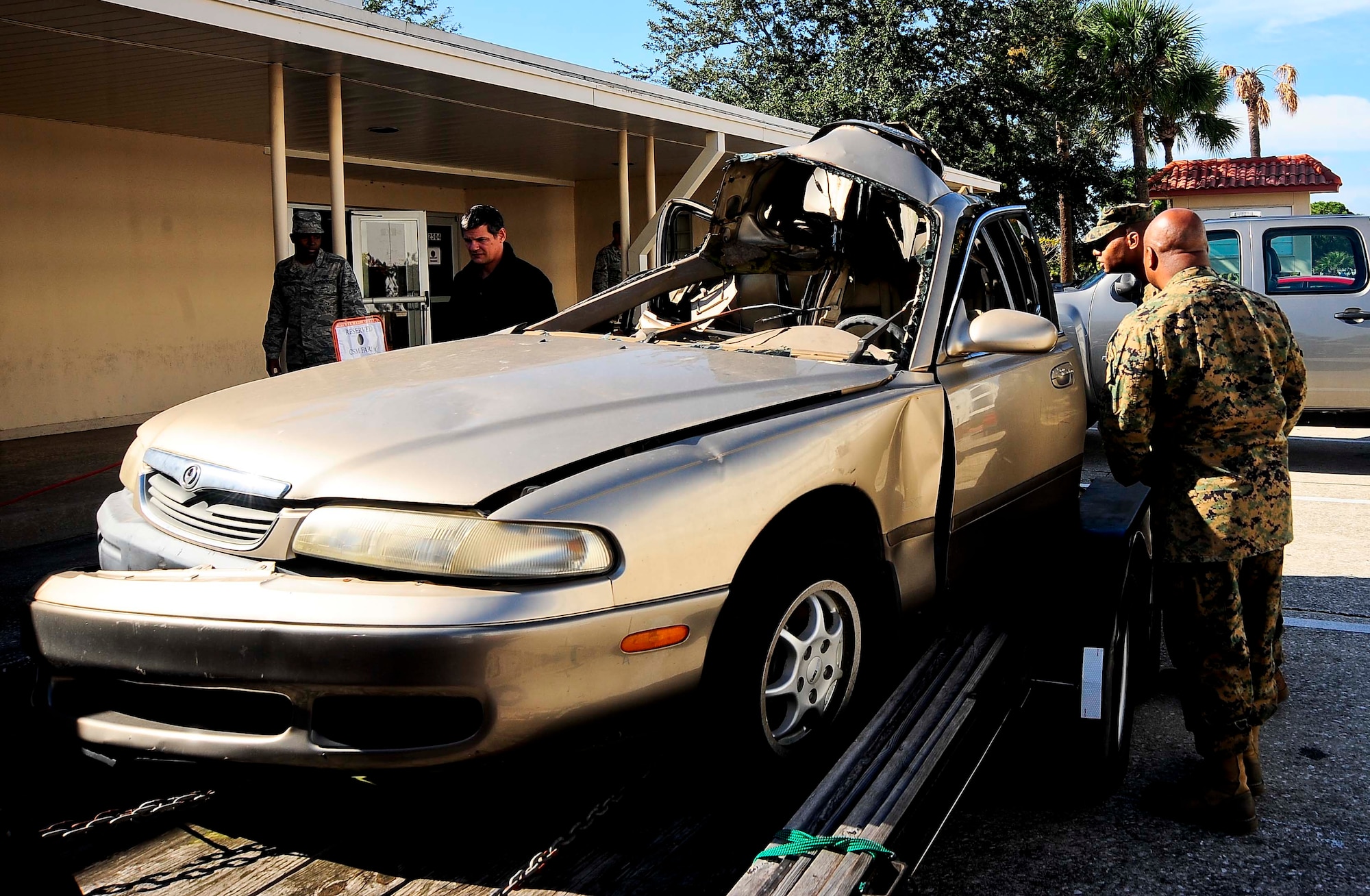Members of Team MacDill look at the car Meagan Napier and Lisa Jo Dickson were driving the night they were killed Dec. 18, 2014 at MacDill Air Force Base, Fla. More than 12 years ago, Napier and Dickson were killed by drunken driver Eric Smallridge as they headed home. (U.S. Air Force photo by Senior Airman Melanie Bulow-Gonterman/Released)