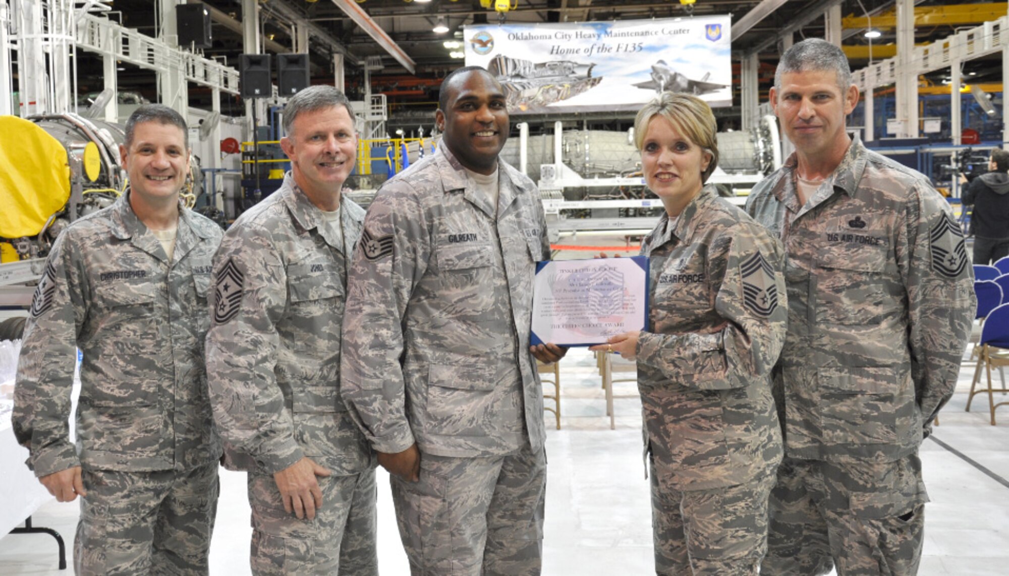 “November’s Chief’s Choice Award” presentation by the Tinker Chief's Group recognizes one of Tinker’s finest, Staff Sgt. James Gilreath of the 545th Propulsion Maintenance Squadron for his utmost dedication to duty in direct support of Initial Operations Capability for the USMC F-35 Joint Strike Fighter. He is the only enlisted military member task certified to perform necessary modifications to the F135 engine. Pictured, from left, are 72nd Air Base Wing Command Chief Master Sgt. Thomas Christopher, Air Force Sustainment Center Command Chief Master Sgt. Gregg Jones, Sergeant Gilreath, Chief’s Group President Chief Master Sgt. Larea Chapman, 72nd Medical Group, and Chief Master Sgt. Brian Dickirson, 552nd Air Control Wing. The Chief’s Choice Award identifies those outstanding individuals who have stepped-up with consistent professionalism, leadership and devotion to duty while providing that positive role model to peers and supervisors alike. (Courtesy photo)