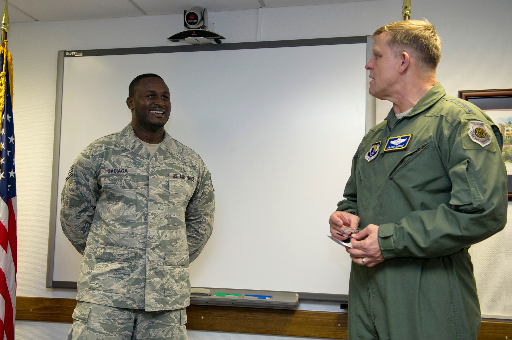 Tech. Sgt. Mauhamed Gadiaga, U.S. Air Forces in Europe and Air Forces Africa Surgeon General’s Office international health NCO, smiles as Gen. Frank Gorenc, USAFE-AFAFRICA commander, notifies him that he is promoted to technical sergeant effective immediately, Dec. 18, 2014 Ramstein Air Base, Germany. Gadiaga was promoted through the Stripes for Exceptional Airman program. (U.S. Air Force photo/Tech. Sgt. Benjamin Wilson)