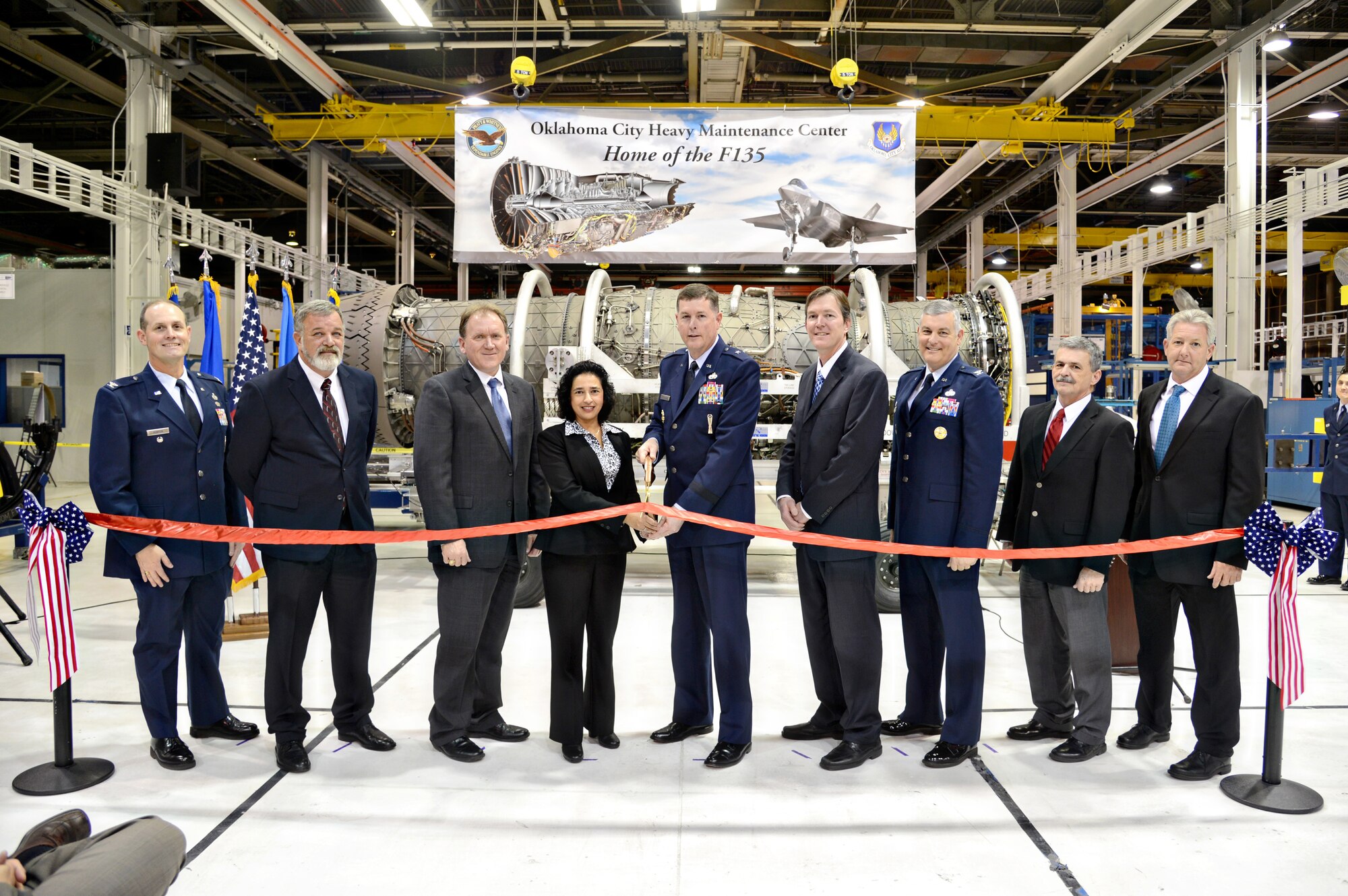 A ribbon cutting ceremony was held Dec. 15 for a Heavy Maintenance Center at the Oklahoma City Air Logistics Complex. The depot will be the nation’s first for the F135 engine, which powers the F-35 Lightning II. Those helping with the ribbon cutting are, from left, Col. Daniel Runyon, director, Global Maintenance, Repair, Overhaul and Update F-35 Joint Program Office; Dean Mullett, Pratt & Whitney; Sam Anderson, general manager of OKC, Pratt & Whitney; Cheryl Lobo, F135 program director, Pratt & Whitney; Brig. Gen. Gene Kirkland, OC-ALC commander; Kevin O'Connor, OC-ALC vice director; Col. Stephen Petters, 76th Propulsion Maintenance Group commander; Michael Barrett, 76th PMXG deputy director; and Michael Opela, 544th Propulsion Maintenance Squadron director. (Air Force photo by Kelly White)

