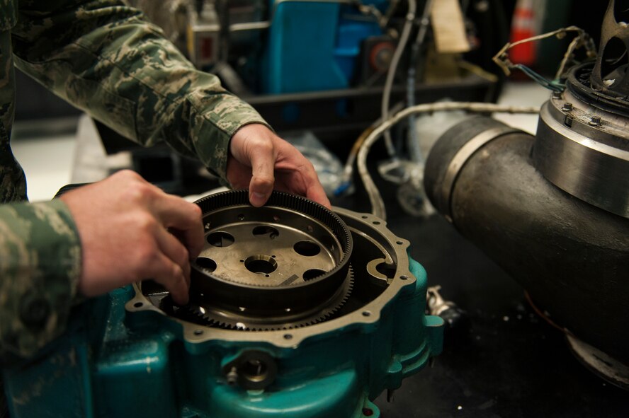 U.S. Air Force Senior Airman Matthew Pelletier, 23d Component Maintenance Squadron aerospace propulsion journeyman, installs a gear onto a GTCP-3650 auxiliary power unit (APU) Dec. 15, 2014, at Moody Air Force Base, Ga. The newly established small gas section has the potential to save 72 hours of maintenance time which decreases the downtime of the A-10C Thunderbolt II by 70 percent. (U.S. Air Force photo by Senior Airman Olivia Bumpers/Released)