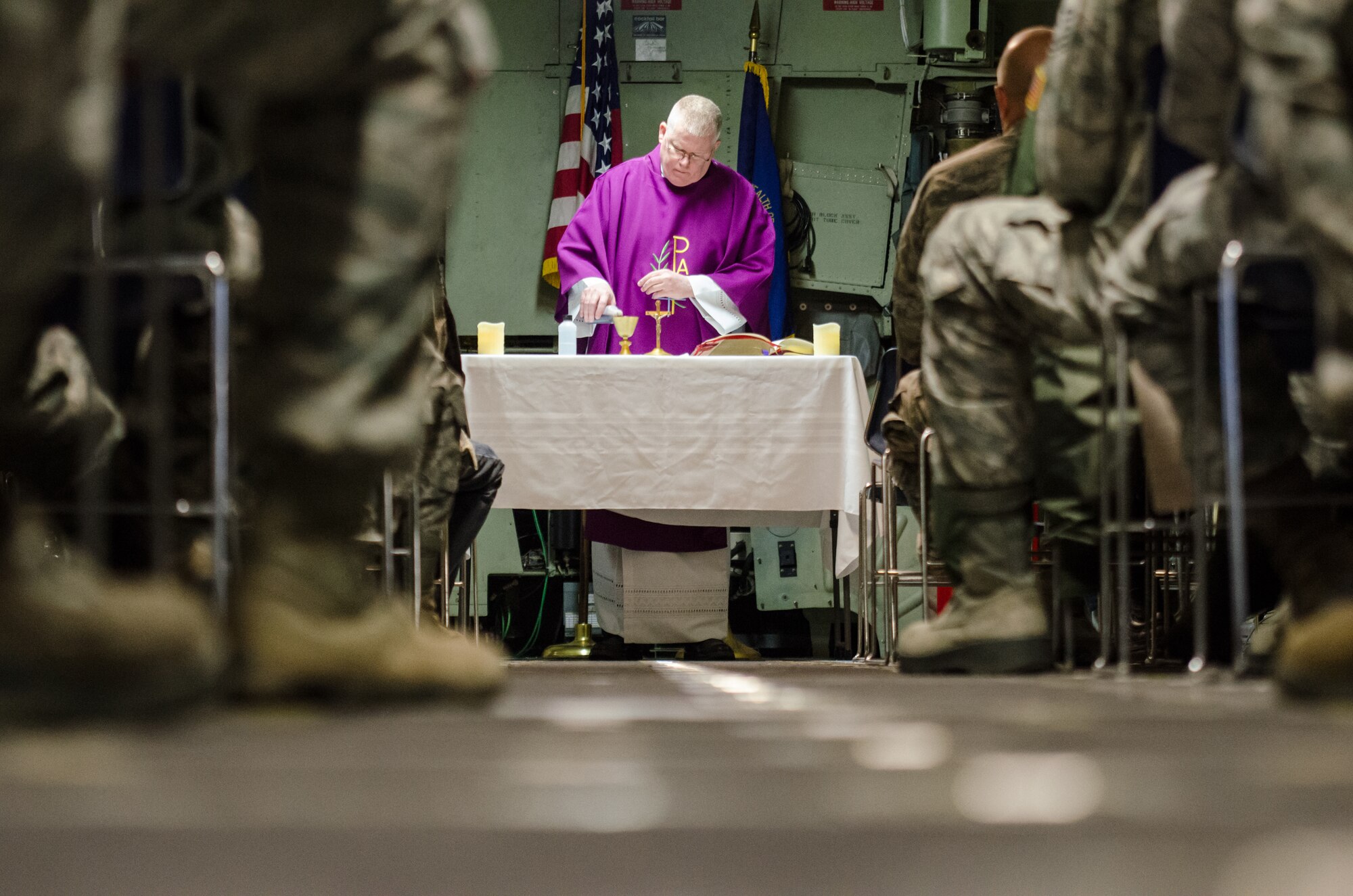 Chaplain (Lt. Col.) Patrick Cooney celebrates his final Mass as Catholic chaplain for the 123rd Airlift Wing at the Kentucky Air National Guard Base in Louisville, Ky., Dec. 7, 2014. Cooney retired from military service the same day, concluding a career of more than 30 years in the active-duty Air Force and Air National Guard. (U.S. Air National Guard photo by Senior Airman Joshua Horton)