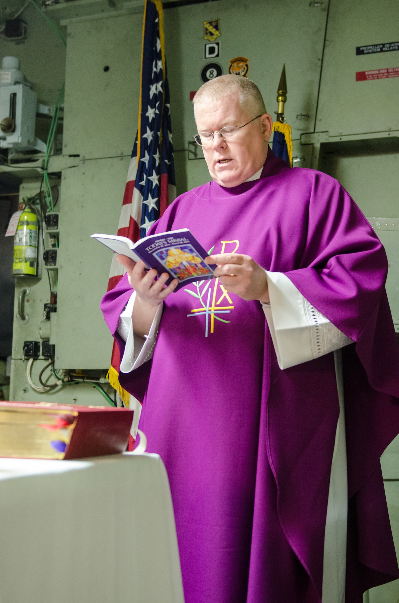 Chaplain (Lt. Col.) Patrick Cooney celebrates his final Mass as Catholic chaplain for the 123rd Airlift Wing at the Kentucky Air National Guard Base in Louisville, Ky., Dec. 7, 2014. Cooney retired from military service the same day, concluding a career of more than 30 years in the active-duty Air Force and Air National Guard. (U.S. Air National Guard photo by Senior Airman Joshua Horton)