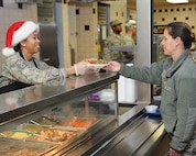 YOUNGSTOWN AIR RESERVE STATION, Ohio – Air Force Reserve Master Sgt. Virginia Wynn, first sergeant of the 910th Maintenance Group, serves the holiday meal at the Community Activity Center here, Dec. 7, 2014. Unit first sergeants serving the holiday meal to the wing’s Citizen Airmen is a long standing 910th Airlift Wing tradition. U.S. Air Force photo/Tech. Sgt. Rick Lisum