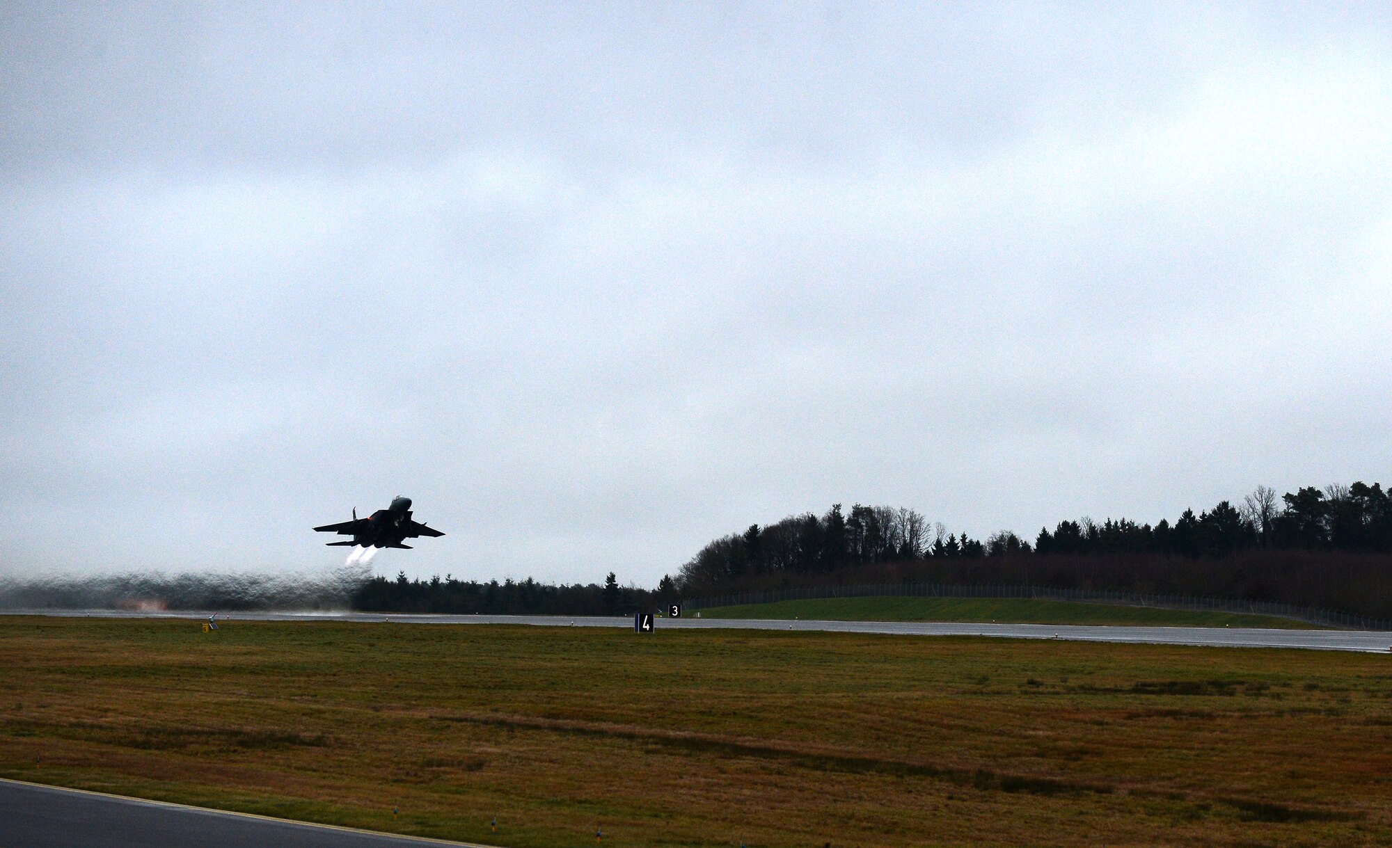 An F-15E Strike Eagle fighter aircraft assigned to the 494th Fighter Squadron at Royal Air Force Lakenheath, England, takes off from the runway during exercise Iron Hand 15-2 at Spangdahlem Air Base, Germany, Dec. 18, 2014. The exercise focused on suppression of enemy air defenses tactics which limits enemy air defenses to allow military assets greater freedom of movement in hostile environments. (U.S. Air Force photo by Airman 1st Class Luke Kitterman/Released)   