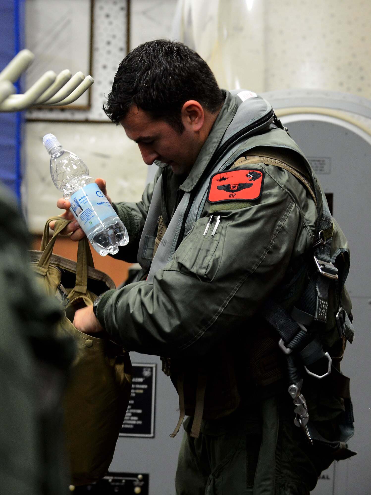 U.S. Air Force Capt. Dale Gogan, 494th Fighter Squadron F-15E Strike Eagle fighter aircraft pilot from Royal Air Force Lakenheath, England, prepares his gear before participating in Iron Hand 15-2 at Spangdahlem Air Base, Germany, Dec. 17, 2014. Iron Hand 15-2 was a U.S.-only air combat exercise with the goal of enhancing interoperability and air readiness. (U.S. Air Force photo by Airman 1st Class Luke Kitterman/Released)