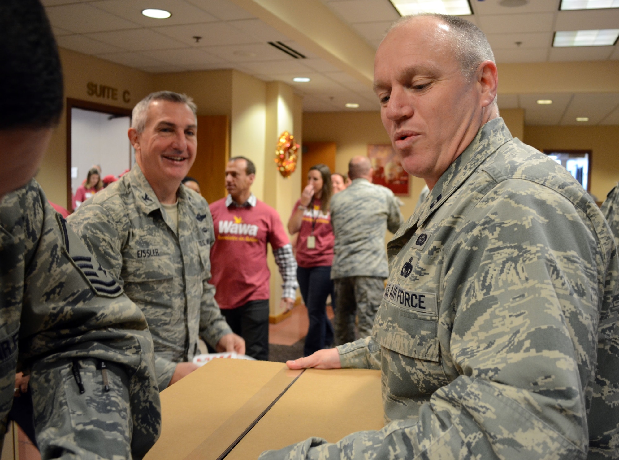Capt. Daniel Taylor, 111th Attack Wing Logistics Readiness Squadron installation deployment officer, and 111th ATKW Commander Col. Howard “Chip” Eissler (left) participate in Operation Stocking Stuffers alongside Wawa associates, creating care packages for deployed service members Nov. 10, 2014, in Media, Pa. Guardsmen and civilian volunteers worked to create more than 9,000 pounds of charitable packages. (U.S. Air National Guard photo by Master Sgt. Christopher Botzum/Released)