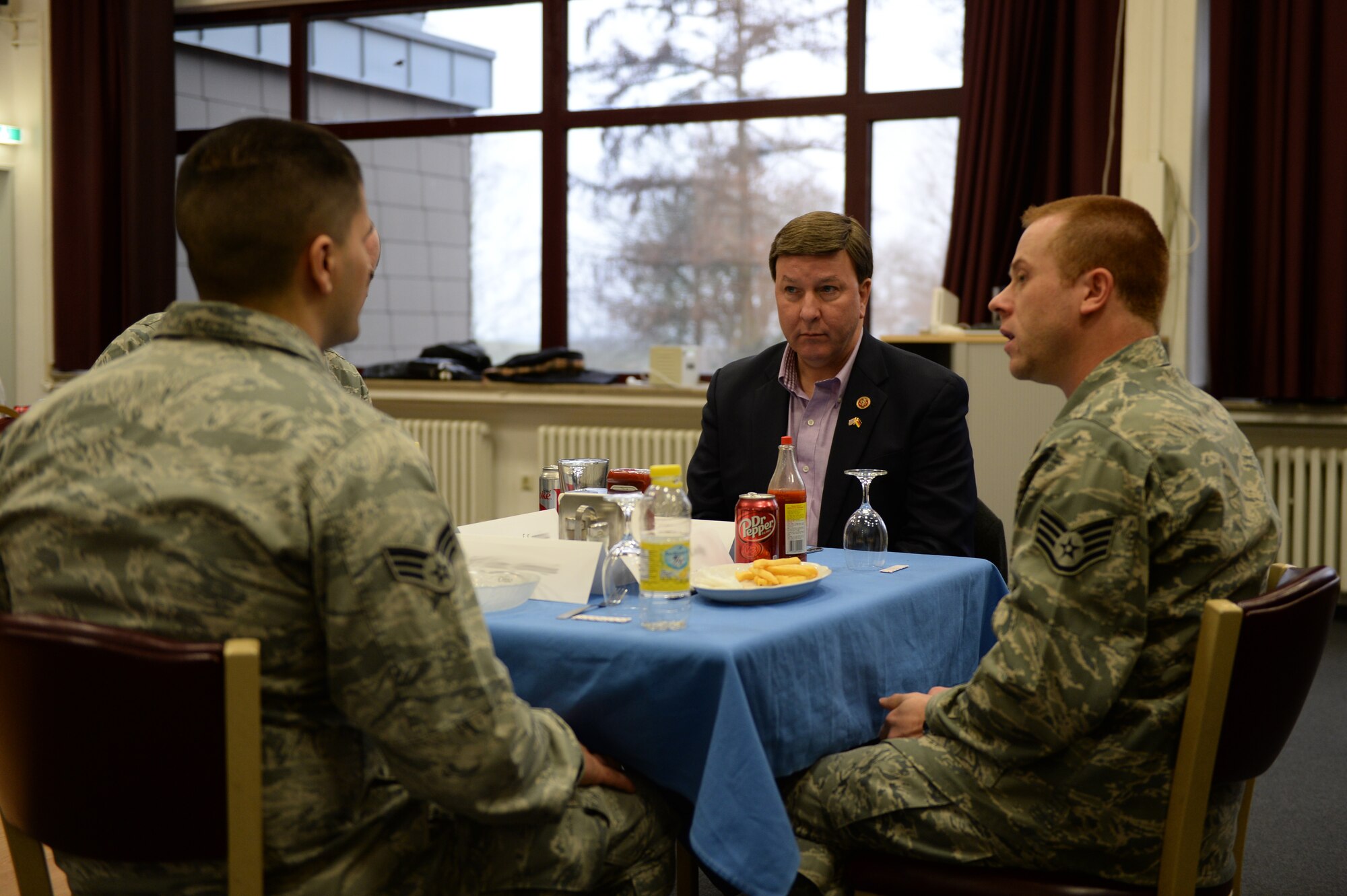 U.S. Rep. Mike Rogers, 3rd District of Alabama congressman, center, talks with 52nd Fighter Wing Airmen at lunch during an immersion visit Dec. 17, 2014, at Buechel Air Base, Germany. Five congressmen received feedback from Airmen and answered their questions. (U.S. Air Force photo by Airman 1st Class Dylan Nuckolls/Released)