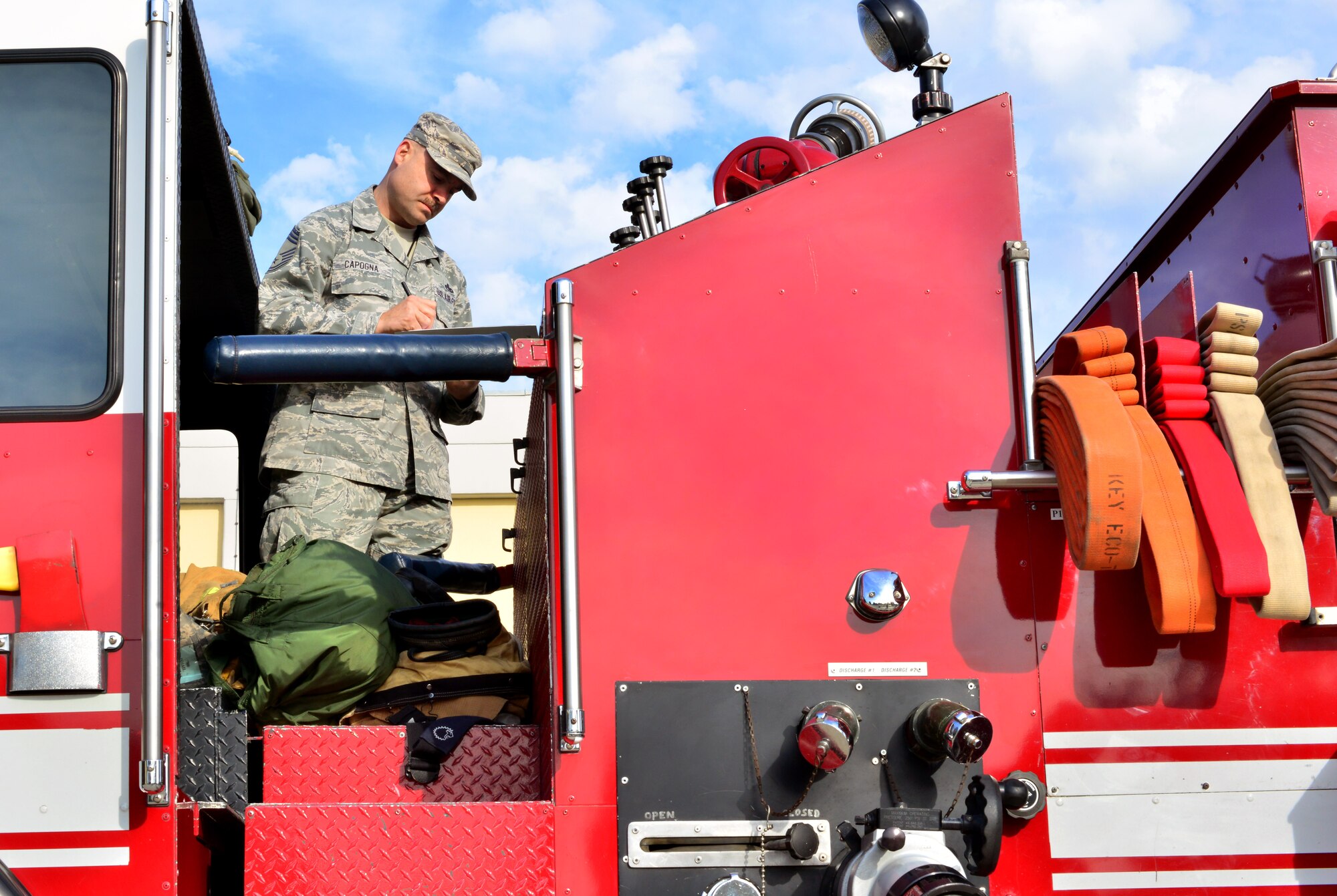 Chief Master Sgt. Zachary Capogna, 39th Maintenance Group superintendent, inspects a fire truck during the 5th Annual Top Wheels competition Dec. 18, 2014, at Incirlik Air Base, Turkey. This quarter’s winner will be determined by which unit has the best overall vehicle interior, exterior and engine. (U.S. Air Force photo by Senior Airman Michael Battles/Released)