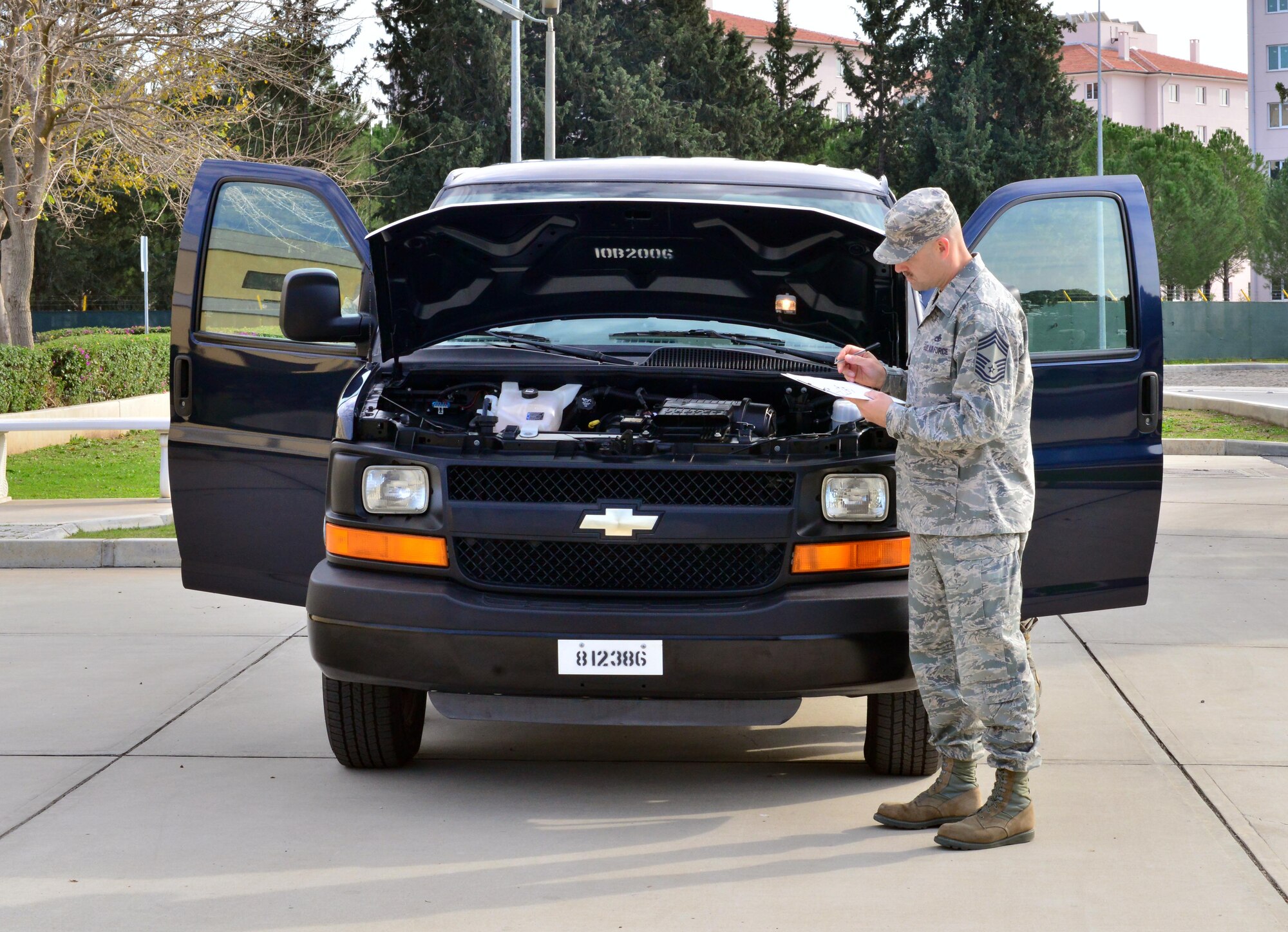 Chief Master Sgt. Zachary Capogna, 39th Maintenance Group superintendent, performs a vehicle inspection during the 5th Annual Top Wheels competition Dec. 18, 2014, at Incirlik Air Base, Turkey. Each quarter, units on base submit their government vehicles for inspection to check their cleanliness. (U.S. Air Force photo by Senior Airman Michael Battles/Released)