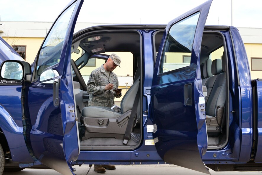 Chief Master Sgt. Zachary Capogna, 39th Maintenance Group superintendent, performs a vehicle inspection during the 5th Annual Top Wheels competition Dec. 18, 2014, at Incirlik Air Base, Turkey. The interior, exterior and engine are inspected for cleanliness during the competition. (U.S. Air Force photo by Senior Airman Michael Battles/Released)