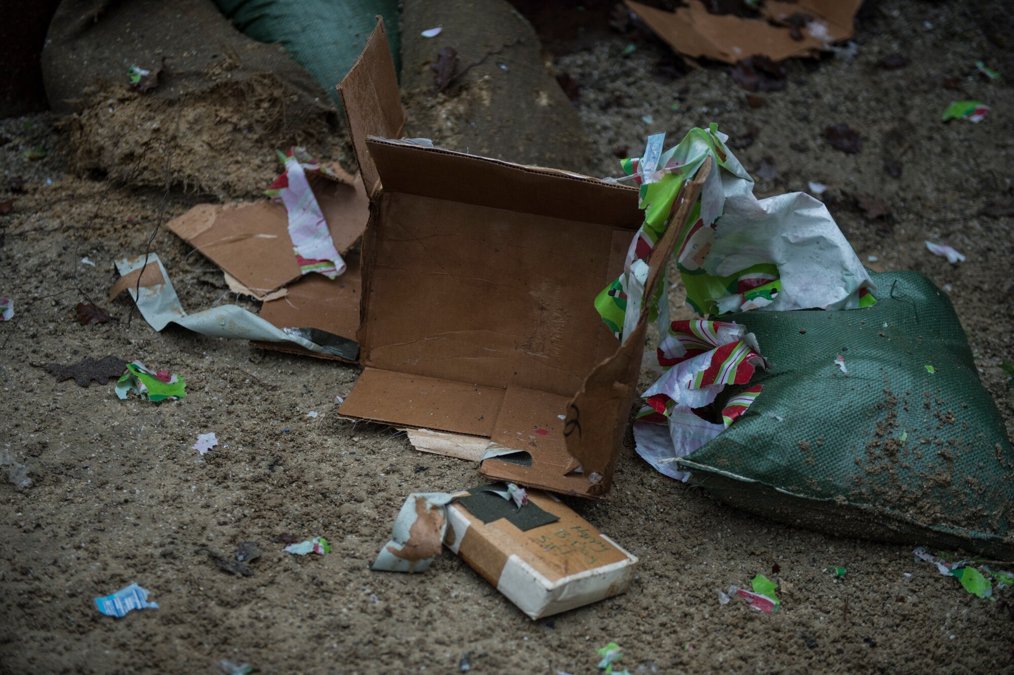 A decimated present is all that remains after a 52nd Civil Engineer Squadron Explosive Ordnance Disposal flight demolition training session on Spangdahlem Air Base, Germany, Dec. 17, 2014. EOD technicians used explosives to attempt to gain access inside two gifts and two large envelopes without damaging the contents. (U.S. Air Force photo by Staff Sgt. Christopher Ruano/Released)
