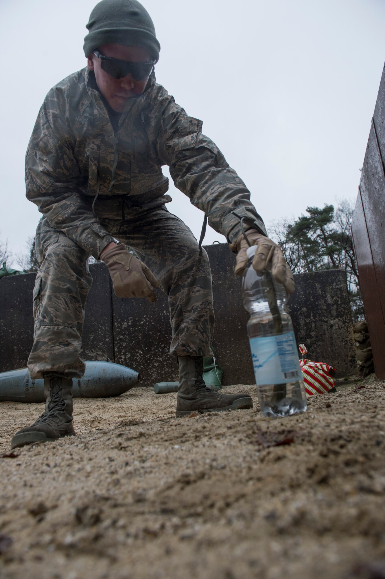 A member of the 52nd Civil Engineer Squadron Explosive Ordnance Disposal flight sets the location of explosives near a wrapped package during a demolition training session on Spangdahlem Air Base, Germany, Dec. 17, 2014. The EOD technicians placed the explosives at a specific distance to open the package without destroying all of its contents. (U.S. Air Force photo by Staff Sgt. Christopher Ruano/Released)