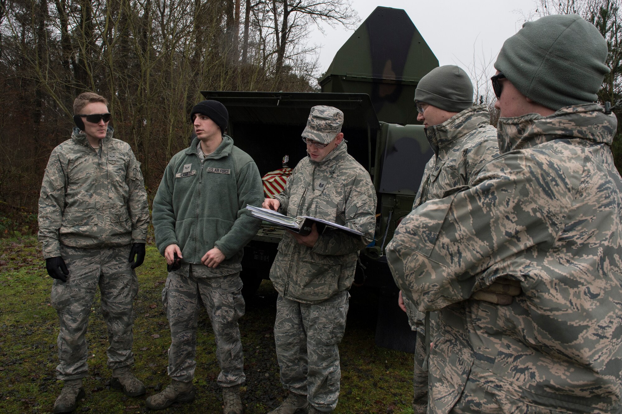 A member of the 52nd Civil Engineer Squadron Explosive Ordnance Disposal flight delivers a safety briefing before a demolition training session on Spangdahlem Air Base, Germany, Dec. 17, 2014. The safety brief described the duties of each EOD member and what the training for the day would entail. (U.S. Air Force photo by Staff Sgt. Christopher Ruano/Released)