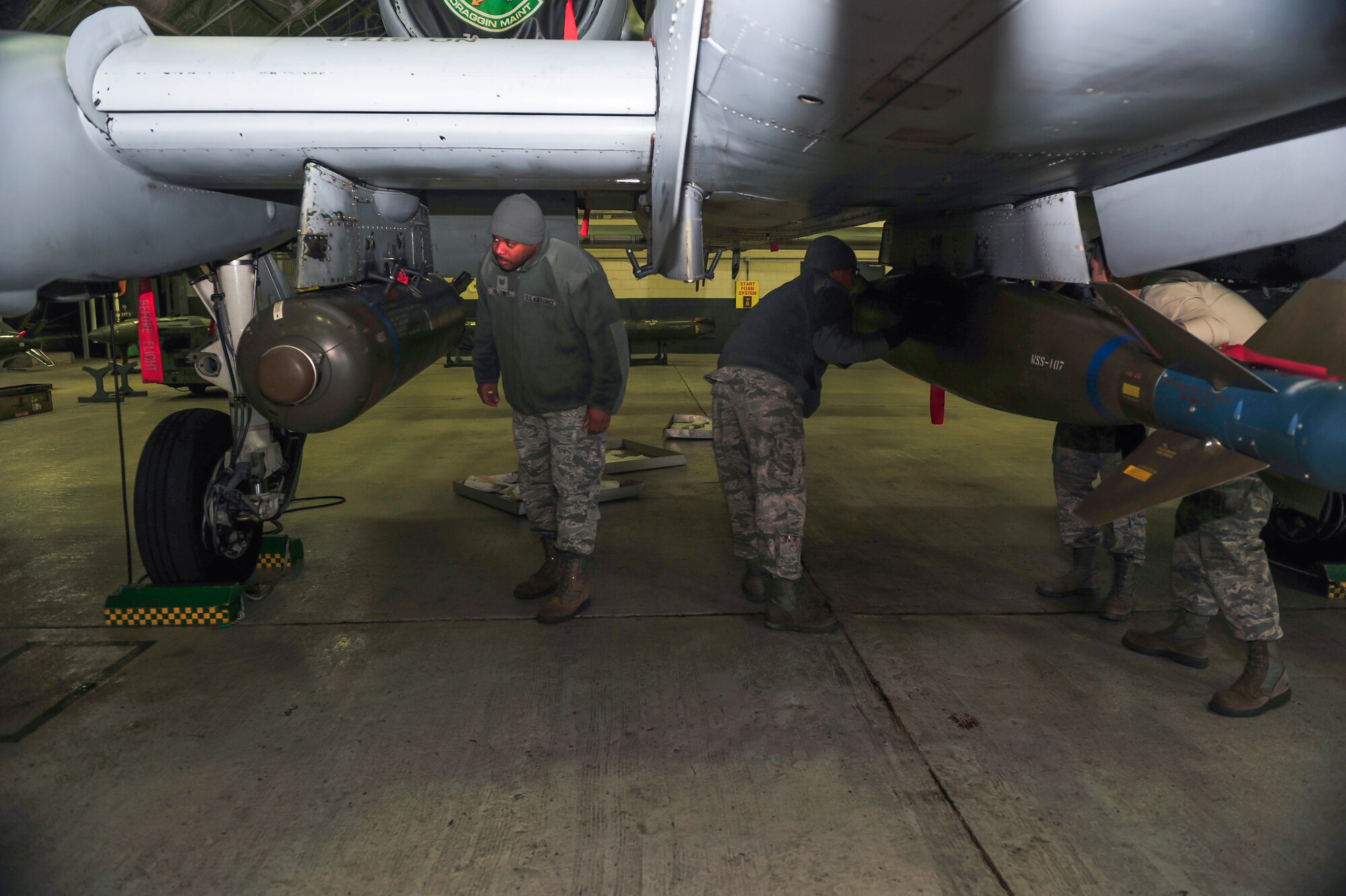 Weapons standardization members inspect the completed work of the 51st Maintenance Operations Flight load crew members Dec. 16, 2014, at Osan Air Base, Republic of Korea. The load crew members are required to be recertified on the 15 different munitions every 30-days. (U.S. Air Force photo by Senior Airman David Owsianka)