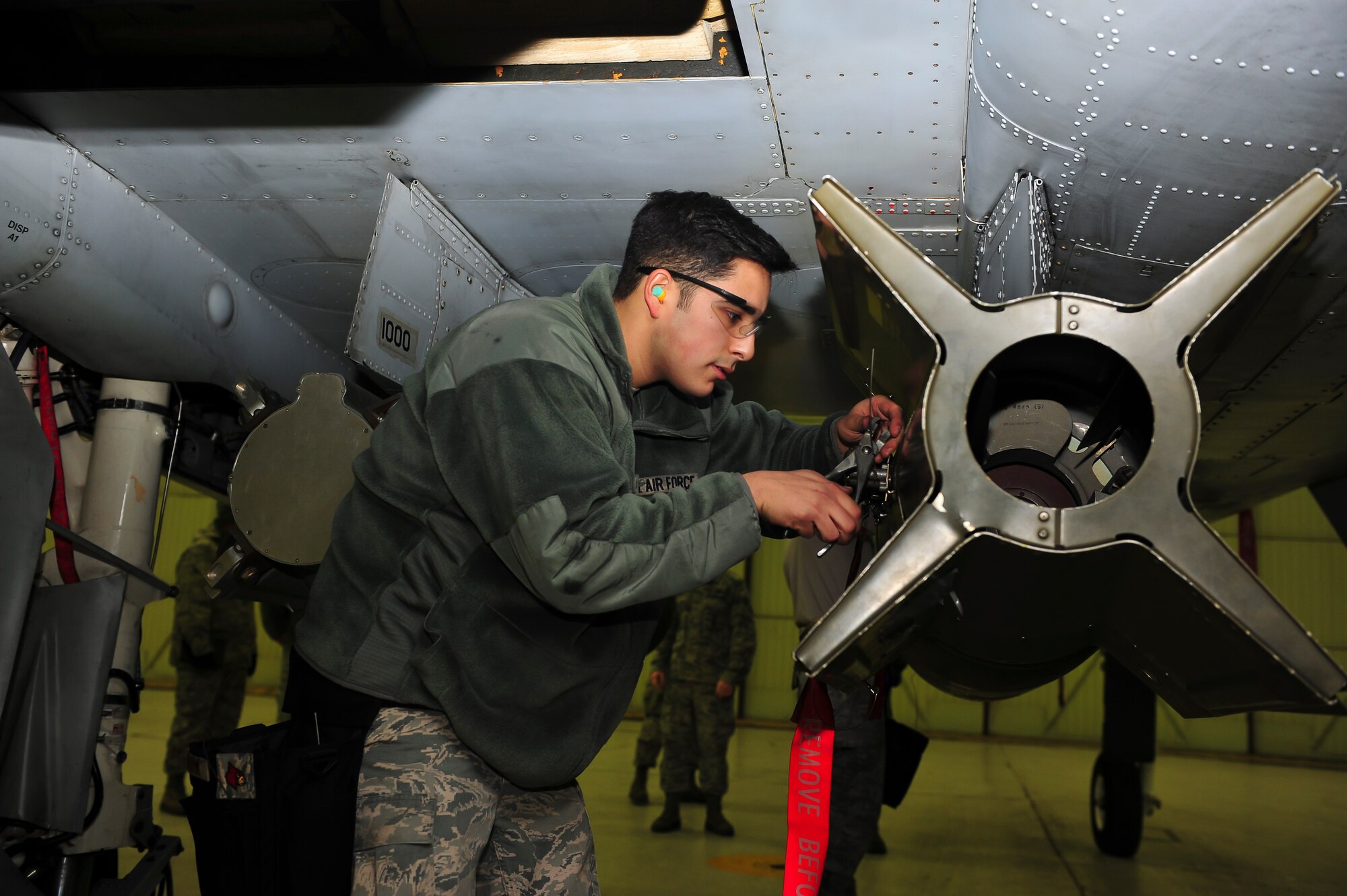 Senior Airman Dylan Logsdon, 51st Maintenance Operations Flight load crew member, cuts an arming wire to approximately one inch during the arming process during a weapons standardization inspection Dec. 16, 2014, at Osan Air Base, Republic of Korea. The load crew members are required to be recertified on the 15 different munitions every 30-days. (U.S. Air Force photo by Senior Airman David Owsianka)