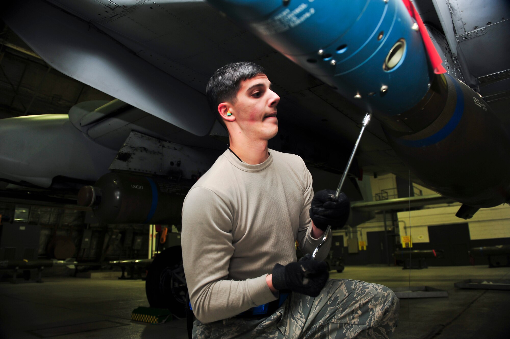 Senior Airman Anthony Cicchino, 51st Maintenance Operations Flight load crew member, tightens a bolt on a computer control group on a bomb during a weapons standardization inspection Dec. 16, 2014, at Osan Air Base, Republic of Korea. The load crew members are required to be recertified on the 15 different munitions every 30-days. (U.S. Air Force photo by Senior Airman David Owsianka)