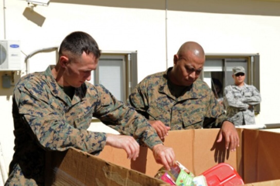 Marine Corps Sgt. Robert Smith, left, and Marine Corps Gunnery Sgt. Omar Hadley deliver toys to the Salvation Army to support the Toys for Tots foundation. U.S. Navy photo by Petty Officer 2nd Class Chelsy Alamina