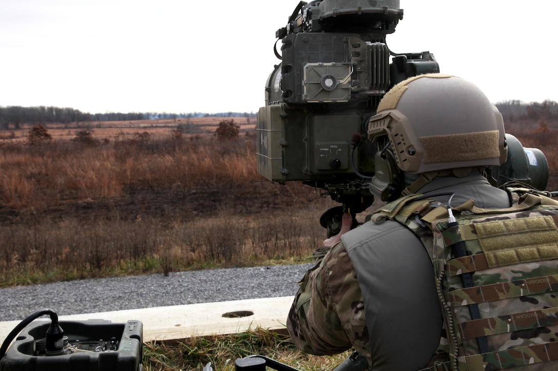 A special forces soldier looks through the optics of a BGM-71 Tube-launched, Optically-tracked, Wire-guided, or TOW, missile, before firing during a partnered training exercise 
on Fort Campbell, Ky., Dec. 9, 2014.