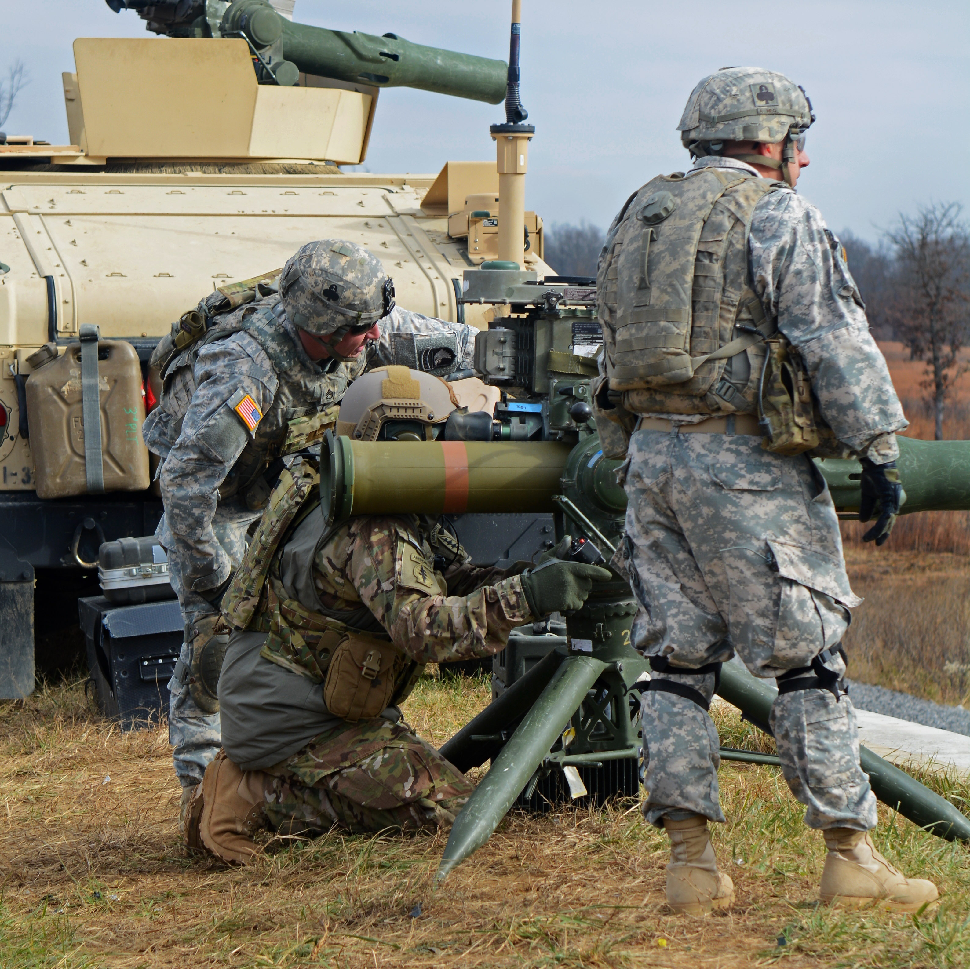 A special forces soldier, center, receives instructions from a soldier