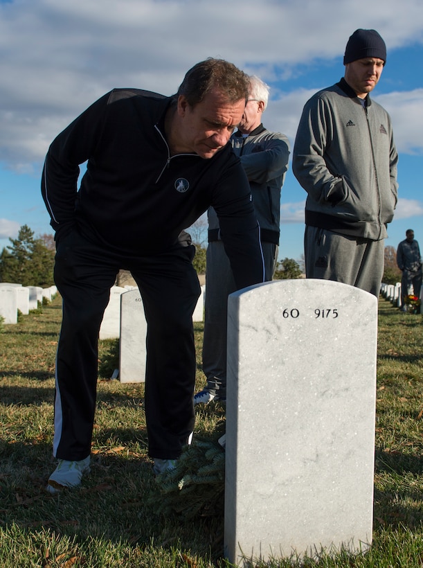 Flip Saunders, coach of the Minnesota Timberwolves basketball team visits a grave at Arlington National Cemetery in Arlington, Va., Dec. 17, 2014. 