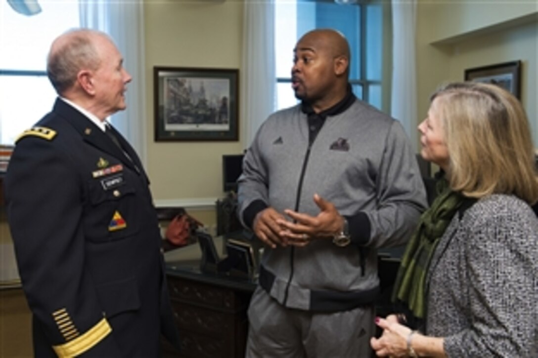 Army Gen. Martin E. Dempsey, chairman of the Joint Chiefs of Staff, and his wife, Deanie, talk with a member of the Minnesota Timberwolves basketball team as part of Commitment to Service, a partnership between the National Basketball Association and Defense Department, at the Pentagon, Dec. 17, 2014.