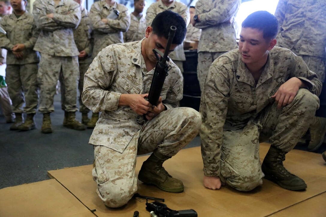 Sgt. Jose Hidalgo, a supply administrative clerk with Combat Logistics Battalion 11, 11th Marine Expeditionary Unit (MEU), removes the hand guards from an M16A4 service rifle during a weapons handling event during a squad competition aboard the amphibious assault ship USS Makin Island (LHD 8), Dec 14. During the squad competition, Marines and Sailors disassembled and reassembled multiple weapon systems for time. The Makin Island Amphibious Ready Group (ARG) and the embarked 11th MEU are deployed in support of maritime security operations and theater security cooperation efforts in the U.S. 5th Fleet area of responsibility. (U.S. Marine Corps photos by Cpl. Demetrius Morgan/Released)  