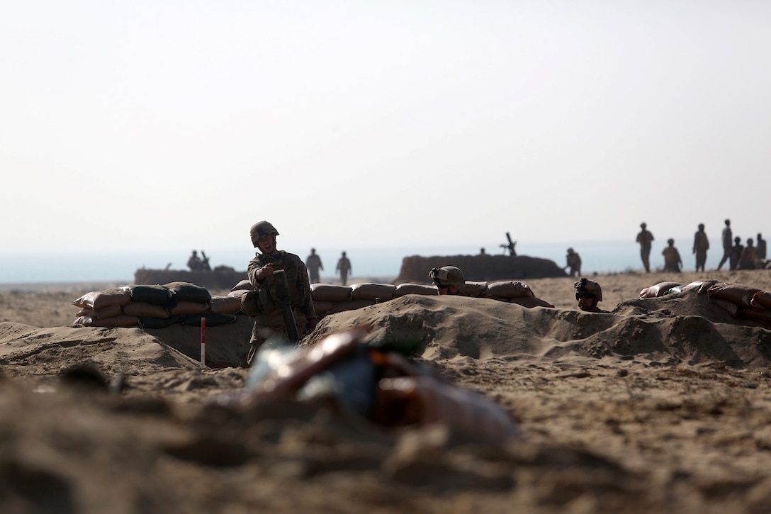U.S. Marine Corps Lance Cpl. Patrick Knauer, a mortarman with Weapons Company, Battalion Landing Team 2nd Battalion, 1st Marines, 11th Marine Expeditionary Unit (MEU), and native of Santa Rosa, Calif., prepares to drop a notional round into an 81mm mortar tube as a part of a dry fire mission during exercise Red Reef 15 in Ras Al Khair, Saudi Arabia, Dec. 15, 2014. Red Reef, is part of a routine theater security cooperation engagement plan between the U.S. Navy, U.S. Marine Corps and Royal Saudi Naval Forces that serves as an excellent opportunity to strengthen tactical proficiency in critical mission areas and support long-term regional security. (U.S. Marine Corps photo by Cpl. Evan R. White/Released)
