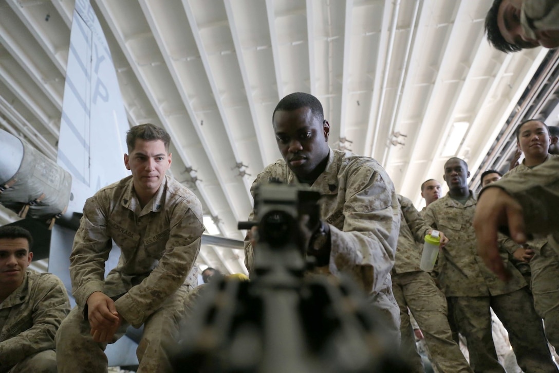 Sgt. Dexroy Smith, an artillery mechanic with Combat Logistics Battalion 11, 11th Marine Expeditionary Unit (MEU), returns a bolt to an M240B machinegun during a weapons handling event during a squad competition aboard the amphibious assault ship USS Makin Island (LHD 8), Dec 14. During the squad competition, Marines and Sailors disassembled and reassembled multiple weapon systems for time.  The Makin Island Amphibious Ready Group (ARG) and the embarked 11th MEU are deployed in support of maritime security operations and theater security cooperation efforts in the U.S. 5th Fleet area of responsibility. (U.S. Marine Corps photos by Cpl. Demetrius Morgan/Released)  