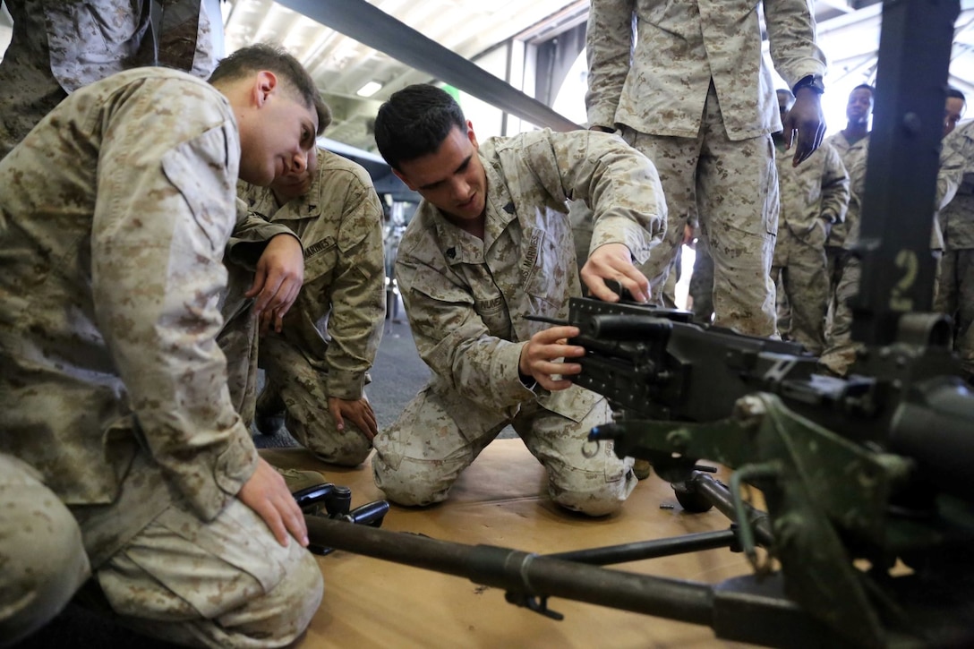 Sgt. Fernando Nunez, a motor transport Marine with Combat Logistics Battalion 11, 11th Marine Expeditionary Unit (MEU), removes the bolt from a .50 caliber machinegun during a weapons handling event during a squad competition aboard the amphibious assault ship USS Makin Island (LHD 8), Dec 14. During the squad competition, Marines and Sailors disassembled and reassembled multiple weapon systems for time. The Makin Island Amphibious Ready Group (ARG) and the embarked 11th MEU are deployed in support of maritime security operations and theater security cooperation efforts in the U.S. 5th Fleet area of responsibility. (U.S. Marine Corps photos by Cpl. Demetrius Morgan/Released)   