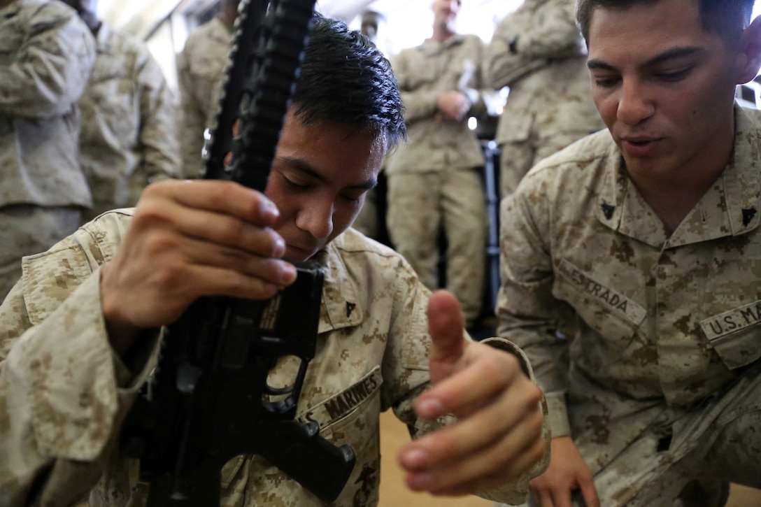 Lance Cpl. Fleming Banally Jr., a refrigeration mechanic with Combat Logistics Battalion 11, 11th Marine Expeditionary Unit (MEU), participates in a weapons handling event during a squad competition aboard the amphibious assault ship USS Makin Island (LHD 8), Dec 14. During the squad competition, Marines and Sailors disassembled and reassembled multiple weapon systems for time. The Makin Island Amphibious Ready Group (ARG) and the embarked 11th MEU are deployed in support of maritime security operations and theater security cooperation efforts in the U.S. 5th Fleet area of responsibility. (U.S. Marine Corps photos by Cpl. Demetrius Morgan/Released)    
