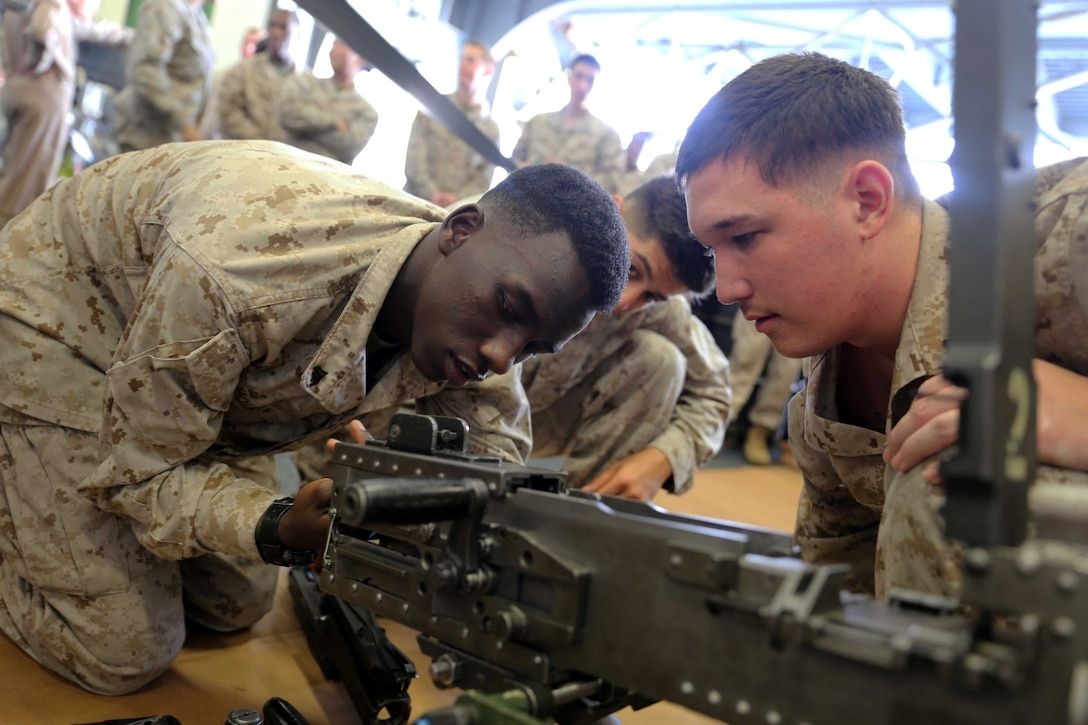 Cpl. Martin Holeman, a supply administrative clerk with Combat Logistics Battalion 11, 11th Marine Expeditionary Unit (MEU), removes the bolt from a .50 caliber machinegun during a weapons handling event during a squad competition   aboard the amphibious assault ship USS Makin Island (LHD 8), Dec 14. During the squad competition, Marines and Sailors disassembled and reassembled multiple weapon systems for time. The Makin Island Amphibious Ready Group (ARG) and the embarked 11th MEU are deployed in support of maritime security operations and theater security cooperation efforts in the U.S. 5th Fleet area of responsibility. (U.S. Marine Corps photos by Cpl. Demetrius Morgan/Released) 