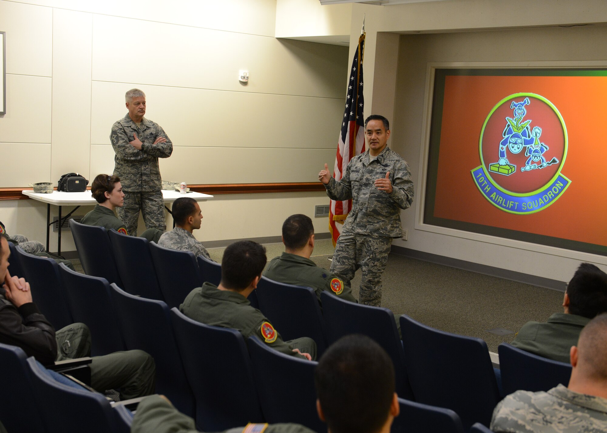 Col. David Kumashiro (middle), 62nd Airlift Wing commander, addresses members of the 10th Airlift Squadron at a commanders call in the 10th AS auditorium, Dec. 18, 2014 at Joint Base Lewis-McChord, Wash. Air Mobility Command made the official announcement Dec. 20, 2014 that the 10th AS along with the 17th AS at Joint Base Charleston, South Carolina would be inactiviated over the next two years as part of the FY15 President's Budget submission released in March 2014. (U.S. Air Force photo/Master Sgt. Todd Wivell)