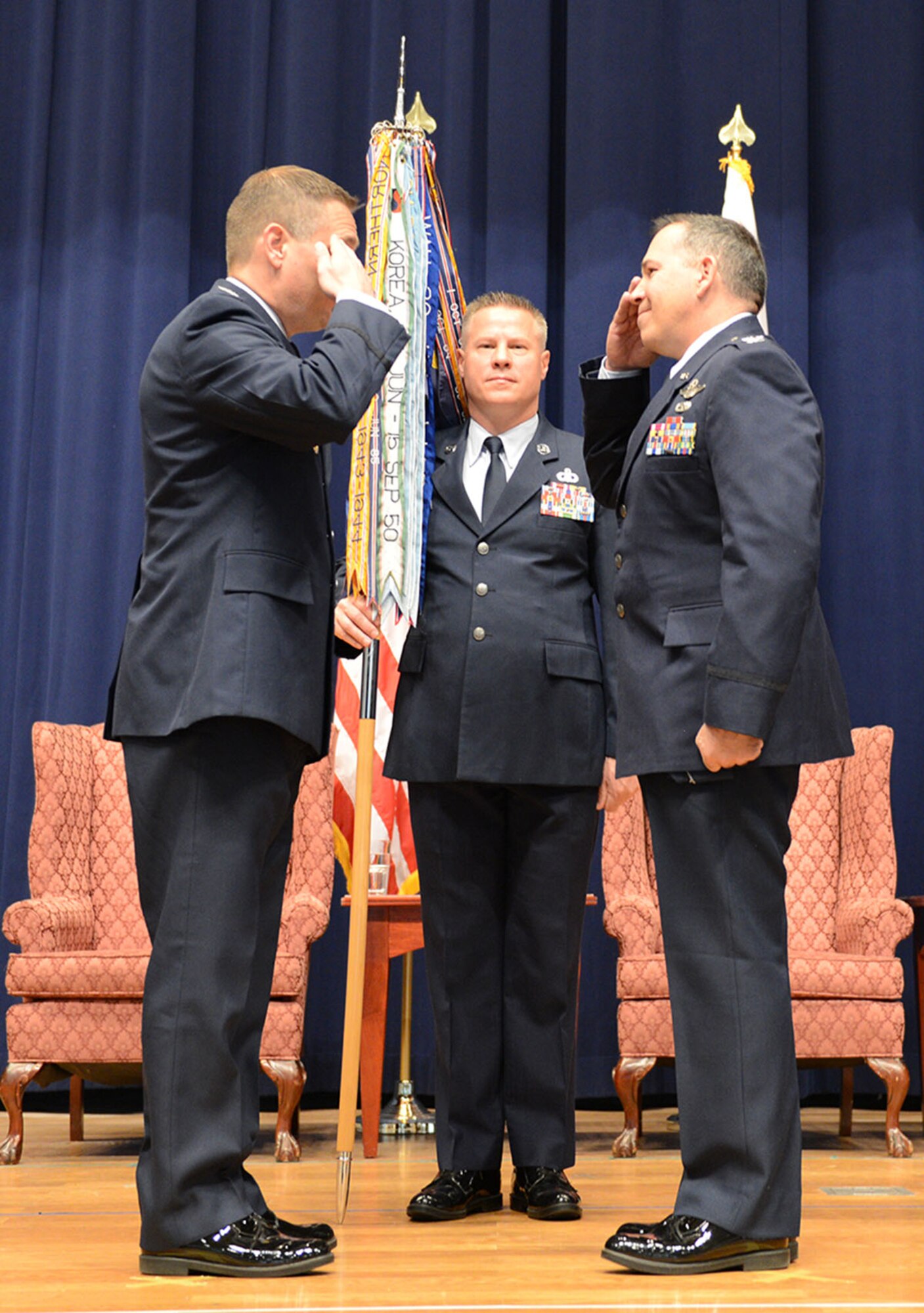 Col. Robert Blagg, 374th Operations Group commander, right, gives his final salute to Col. Douglas DeLaMater, 374th Airlift Wing commander, during the 374 OG Change of Command Ceremony Dec. 19, 2014, at Yokota Air Base, Japan. Blagg finished his 24 years of service in the Air Force at Yokota. (U.S. Air Force photo by Senior Airman Desiree Economides/Released)