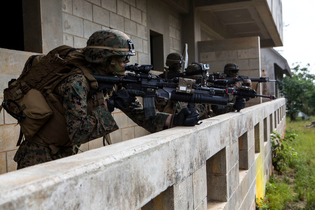 Marines stand their ground during a vertical assault exercise Dec. 10 at Combat Town. After gaining ground in Combat Town, the Marines cleared several buildings and engaged simulated enemy forces. The Marines are with Battalion Landing Team 2nd Battalion, 4th Marines, Company E, 31st Marine Expeditionary Unit. 
