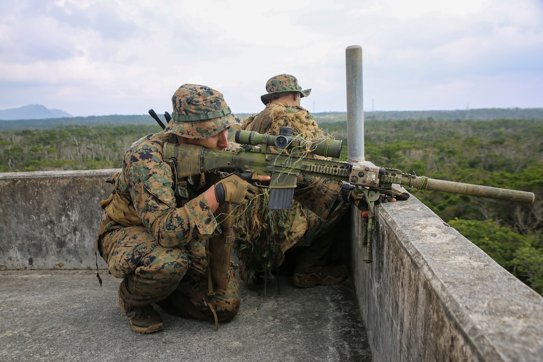 Sergeant Alexander M. Tryon scans the surrounding area for enemy forces during a vertical assault Dec. 10 at Combat Town. After acquiring a strong foothold within the town, the Marines cleared all of the buildings and searched for simulated high-value individuals. Tryon, from Cortland, Ohio, is a scout sniper with Weapons Company, Battalion Landing Team 2nd Battalion, 4th Marines, 31st Marine Expeditionary Unit. 