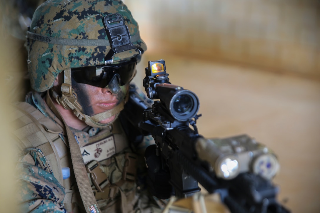 Lance Corporal Alexander J. Perkins sights in while clearing a building during a vertical assault exercise Dec. 10 at Combat Town. While clearing the room, the Marines found multiple simulated high-value individuals and took them into custody. Perkins, from Johnston City, Illinois, is a rifleman with Company E, Battalion Landing Team 2nd Battalion, 4th Marines, 31st Marine Expeditionary Unit. 