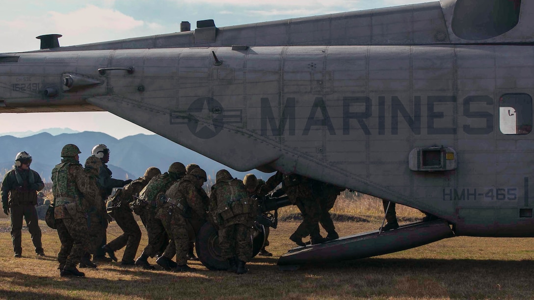Japan Ground Self-Defense Force members load a 120 mm mortar onto a CH-53E Super Stallion, Dec. 7, during Forest Light 15-1 at the Oyanohara Training Area in Yamato, Kumamoto prefecture, Japan. Forest Light is a routine, semi-annual exercise designed to enhance the U.S. and Japan military partnership, solidify regional security agreements and improve individual and unit-level skills. The JGSDF members are with 42nd Regiment, 8th Division, Western Army, JGSDF. The aircraft is with Marine Heavy Helicopter Squadron 465, Marine Aircraft Group 16, currently assigned to 1st Marine Aircraft Wing, III Marine Expeditionary Force, under the unit deployment program. 